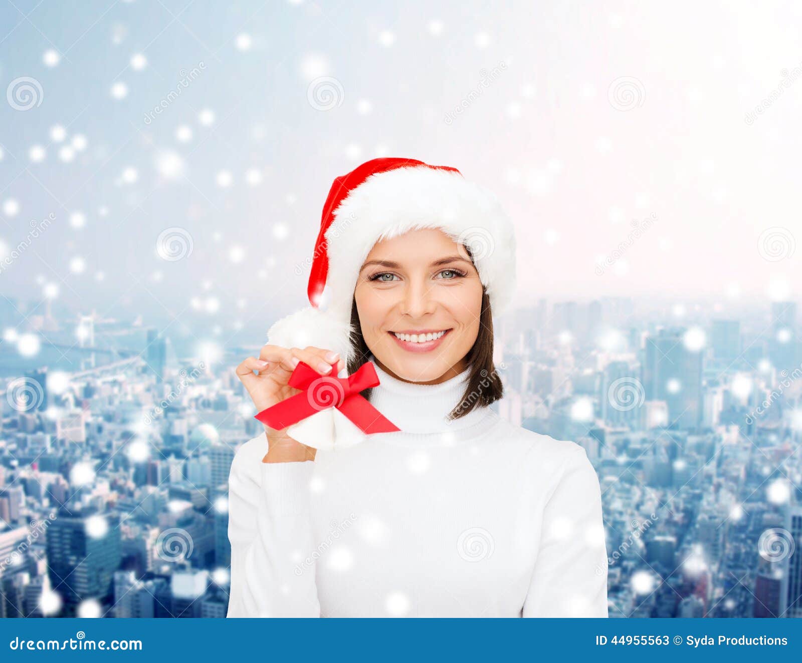 Smiling woman in santa helper hat and jingle bells. Christmas, holidays, winter, happiness and people concept - smiling woman in santa helper hat with jingle bells over snowy city background