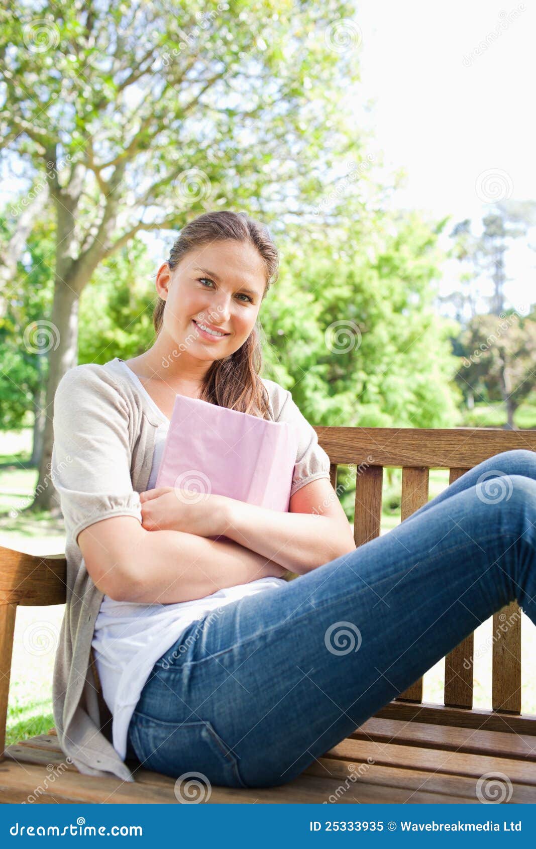 Smiling Woman Sitting on a Park Bench with Her Book Stock Image - Image ...