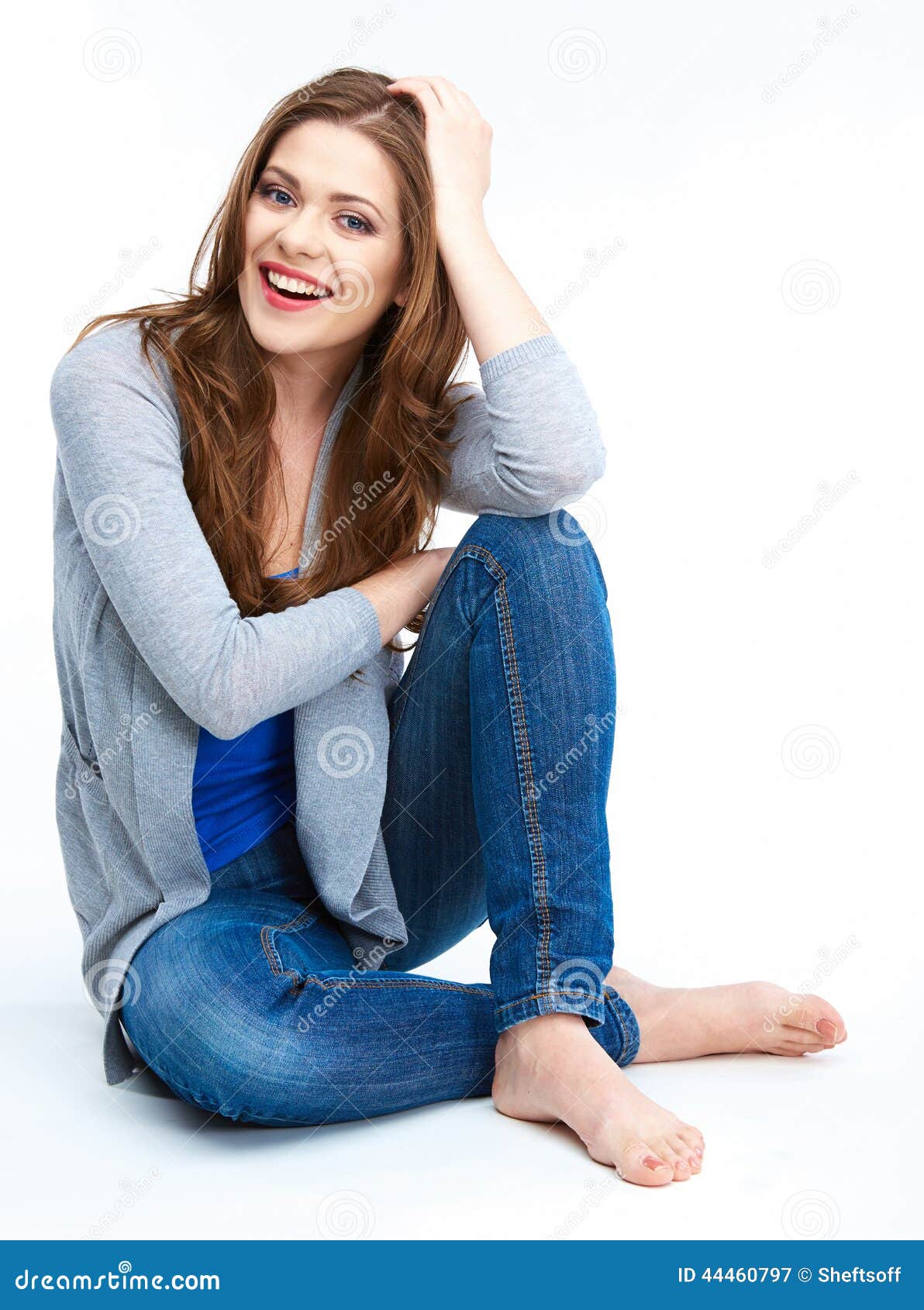 Pretty Woman In Blue Jeans Sitting On White Floor Royalty-Free Stock ...