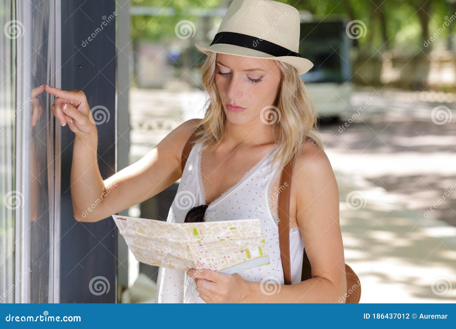 smiling woman studying route map