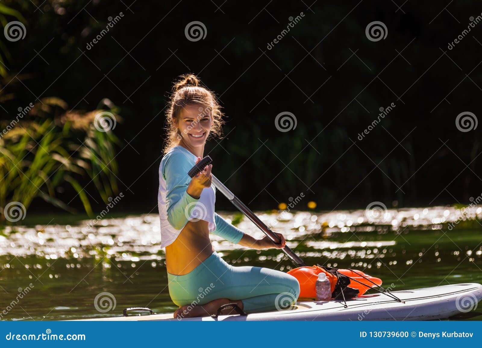 Smiling woman on surfboard stock photo. Image of nature - 130739600