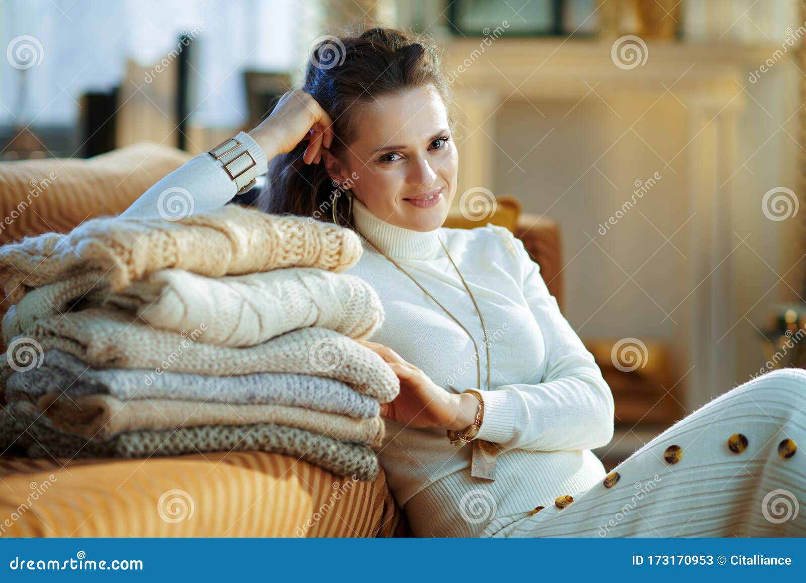 Smiling Woman with Sweaters at Modern Home in Sunny Winter Day Stock ...