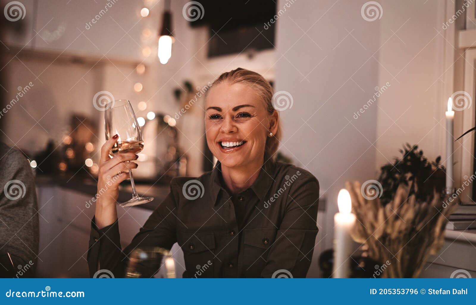 Smiling Woman Talking with Friends Over at a Dinner Party Stock Photo ...