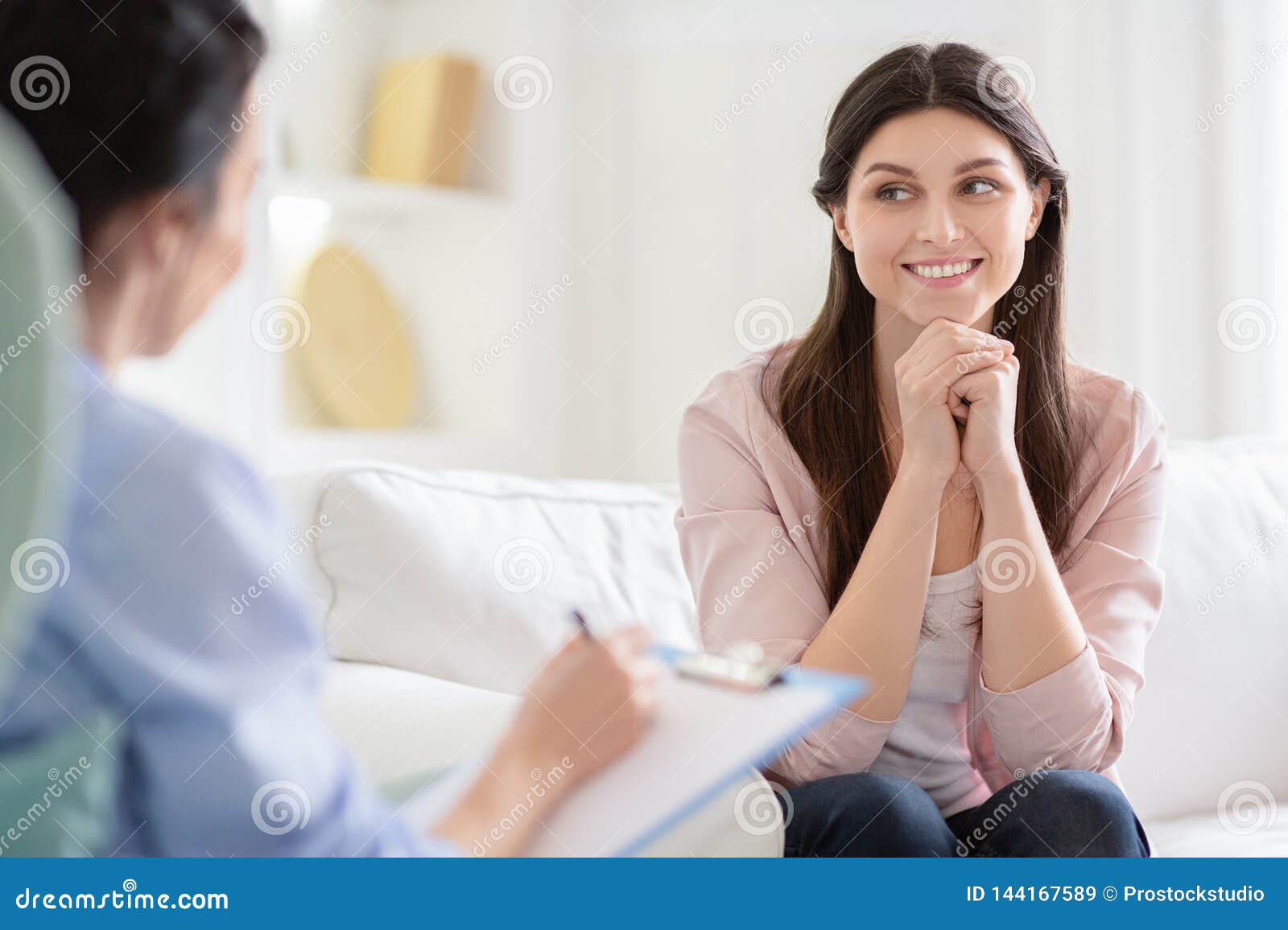smiling woman talking to wellness coach about motivation