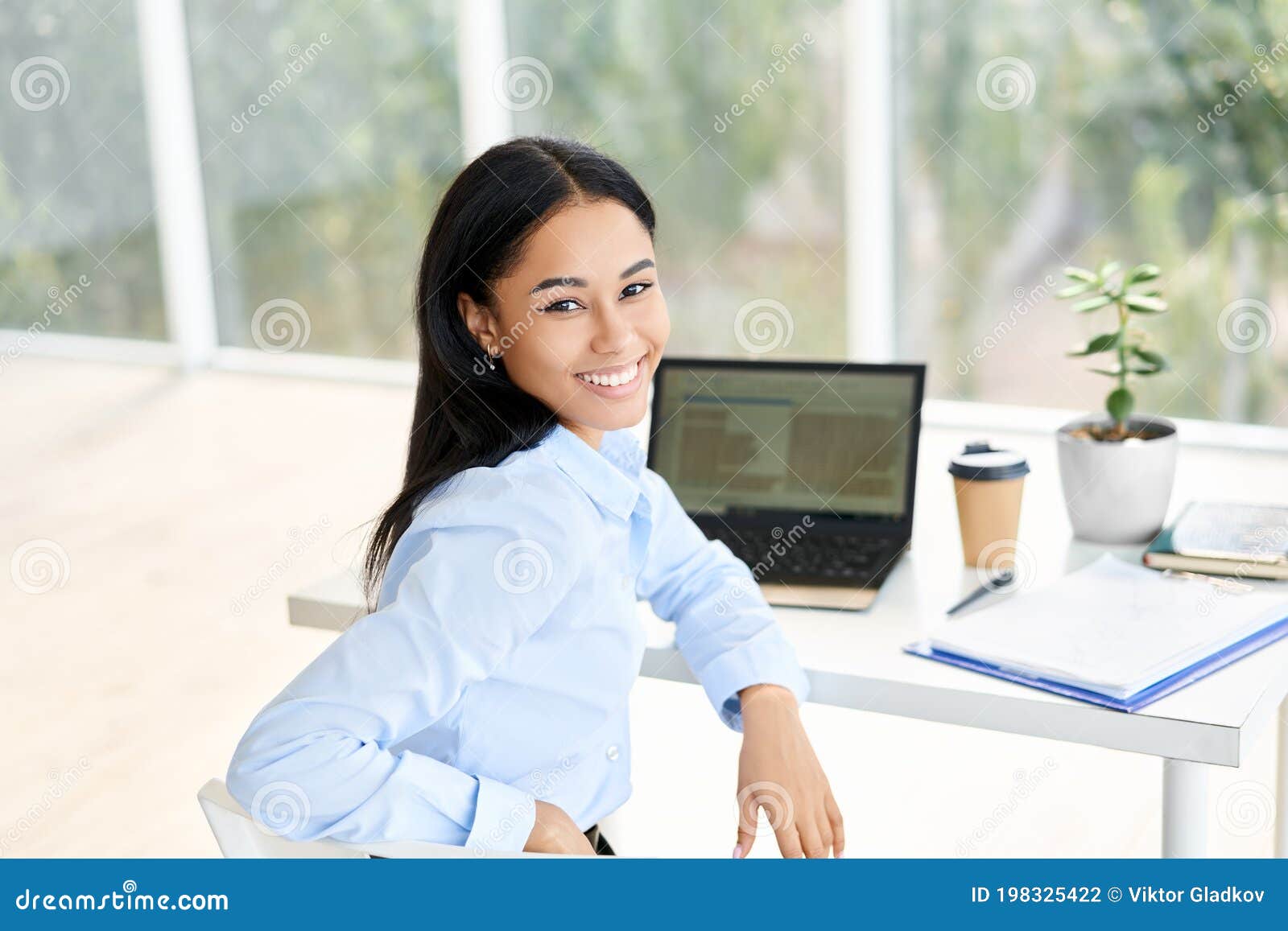 Smiling Young African American Businesswoman Posing at Her Desk in a ...