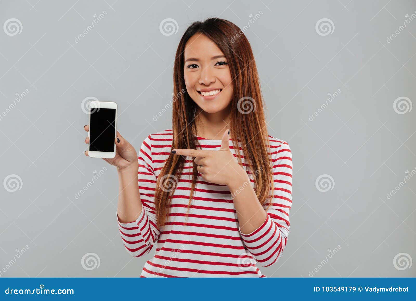 smiling young asian woman showing display of phone