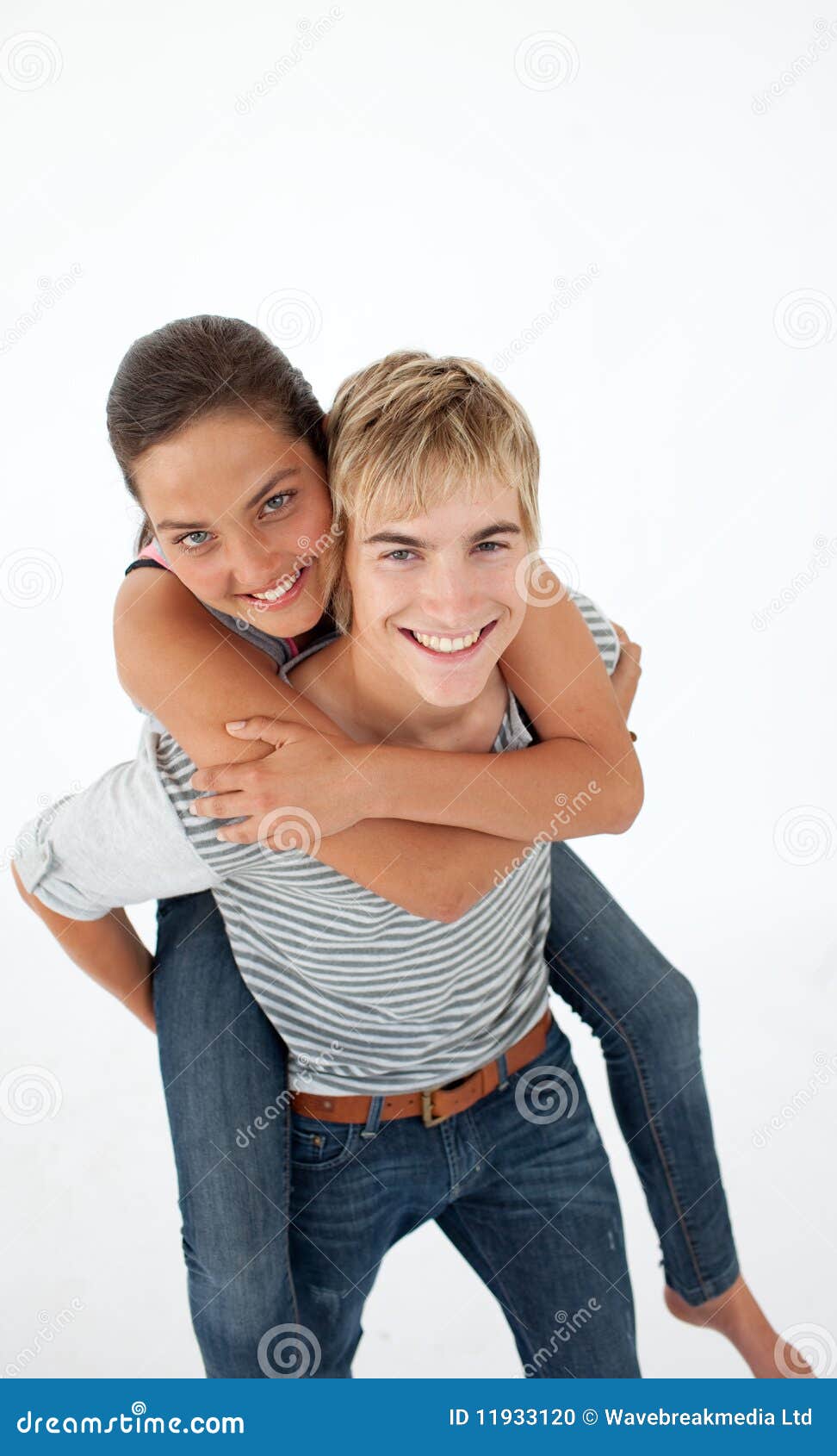 Teenage girl giving friend piggyback ride Stock Photo - Alamy