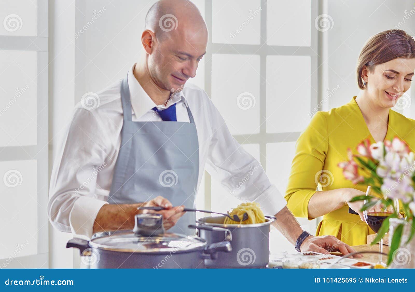 Smiling Young Couple Cooking Food In The Kitchen Stock Image Image Of