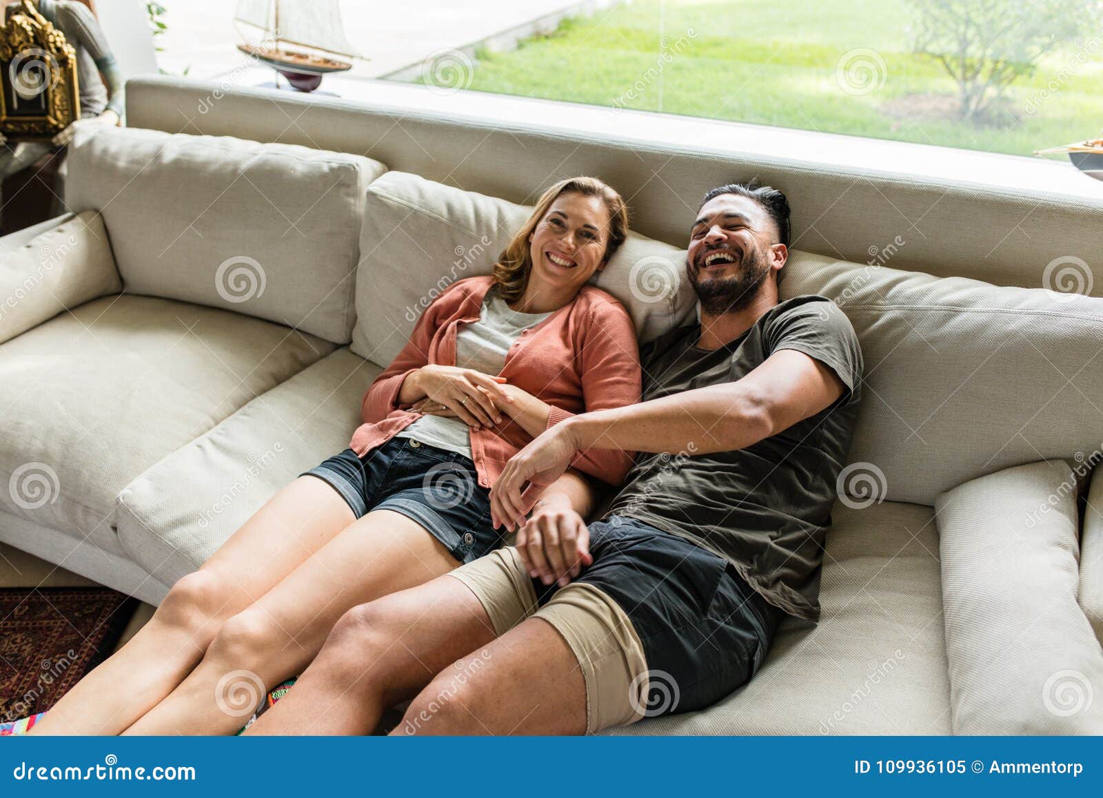 Smiling Young Couple Relaxing On Sofa Stock Image Image Of Smiling Young 109936105