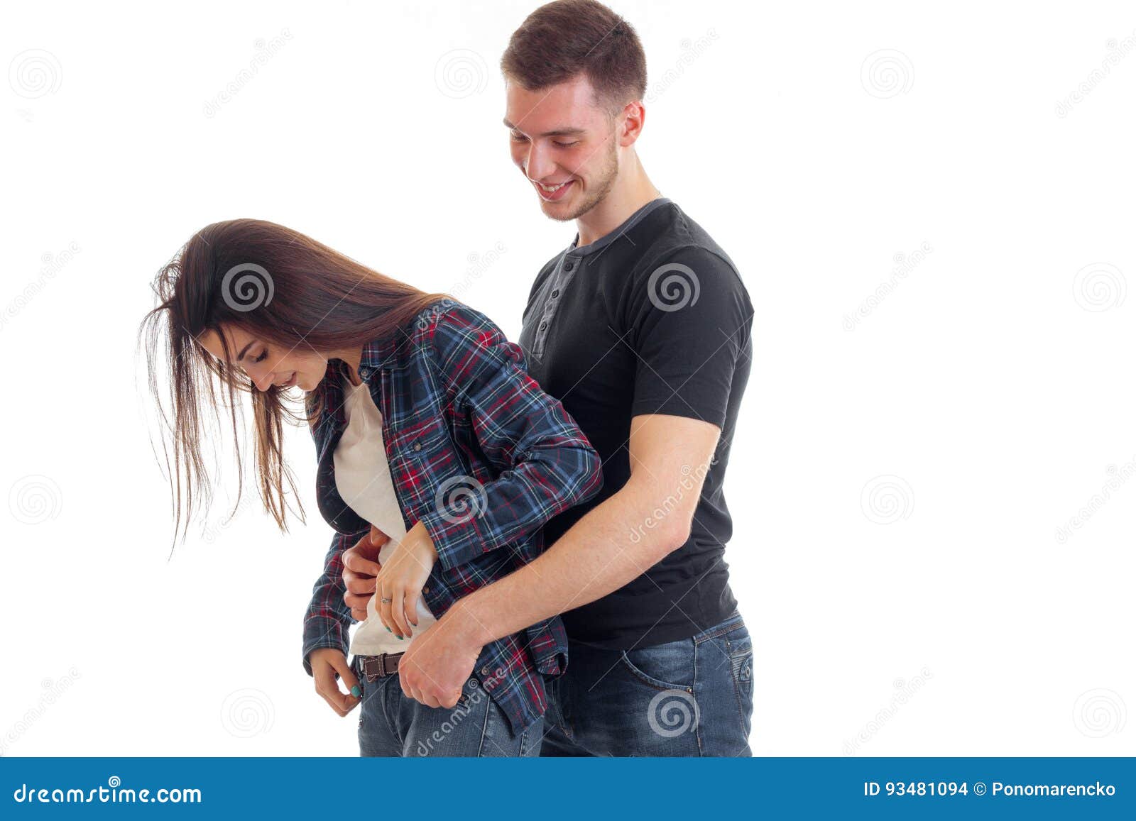 Smiling Young Guy Hugs a Girl`s Waist and she Bent Her Head