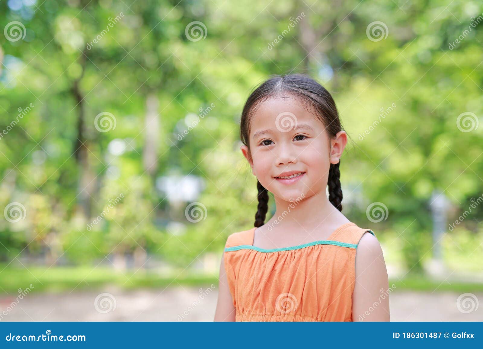 Smiling Young Little Asian Child Girl in the Green Garden with Looking ...