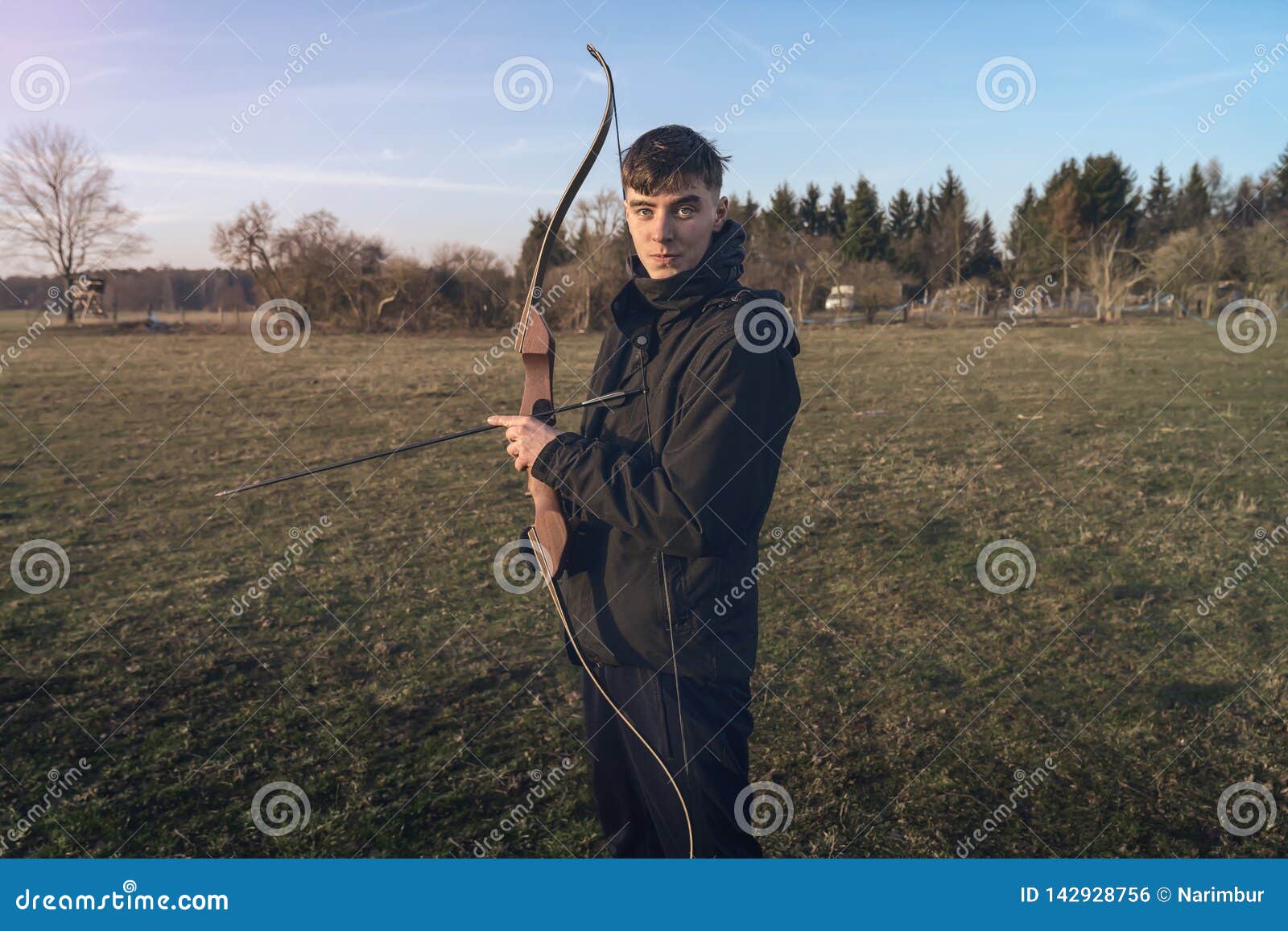 Young man holding a bow stock photo. Image of looking 142928756
