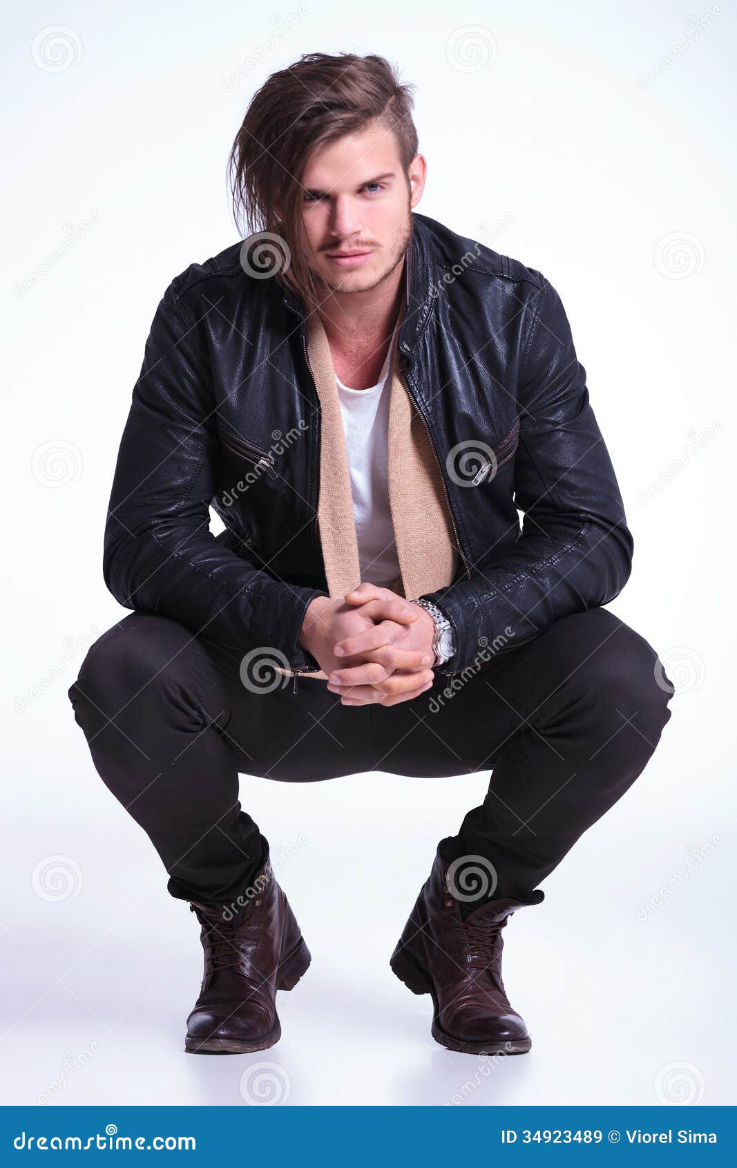 Smiling Young Man In Leather Jacket Standing Crouched 