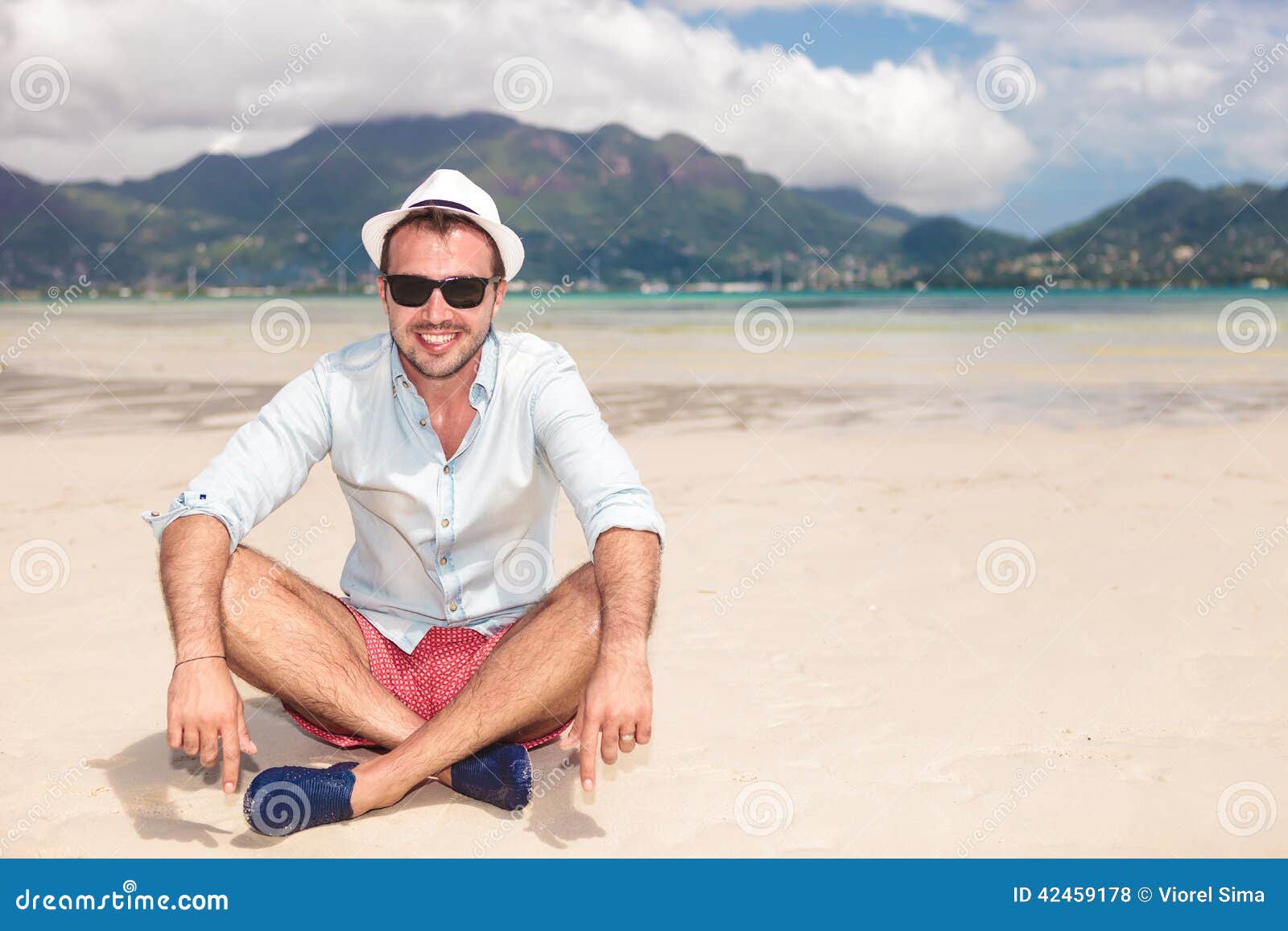Smiling Young Man Sitting on the Beach Stock Photo - Image of fresh ...
