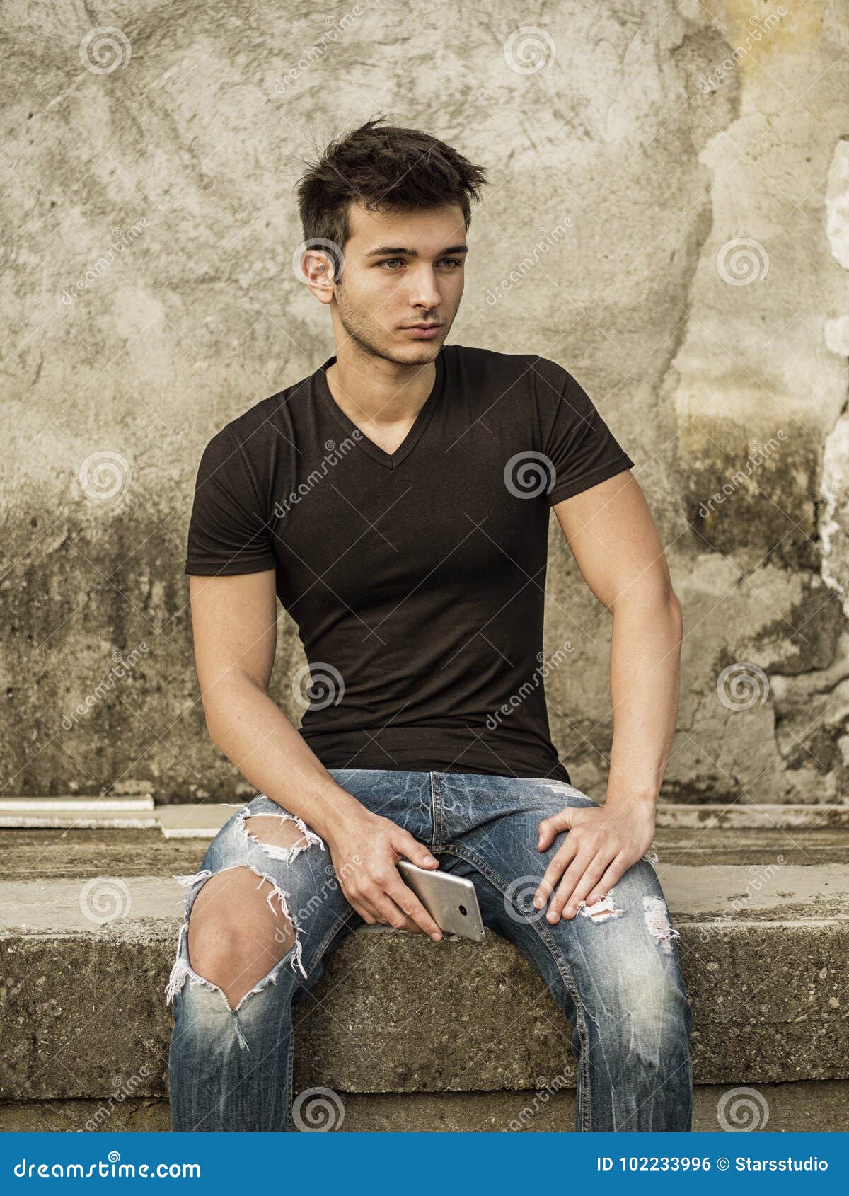 Smiling Young Man Sitting on Concrete Steps. Stock Photo - Image of ...