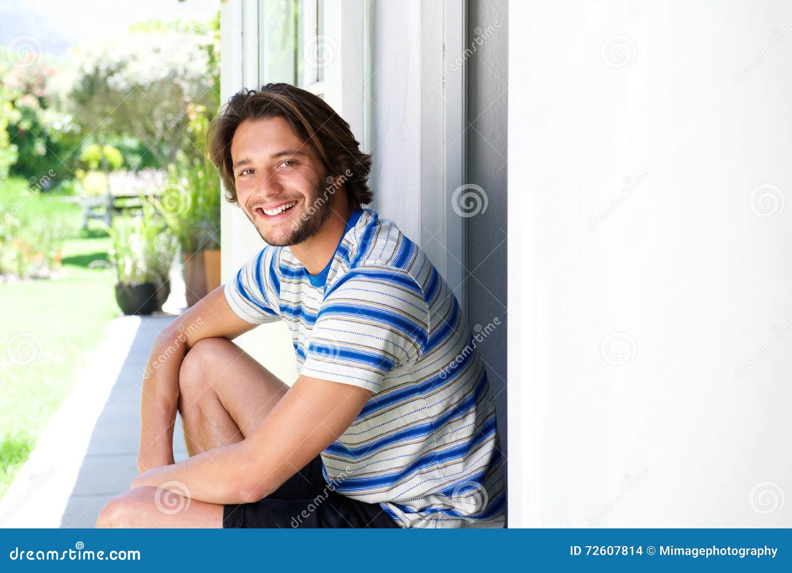 Smiling Young Man Sitting on Patio Outside Stock Photo Image of male