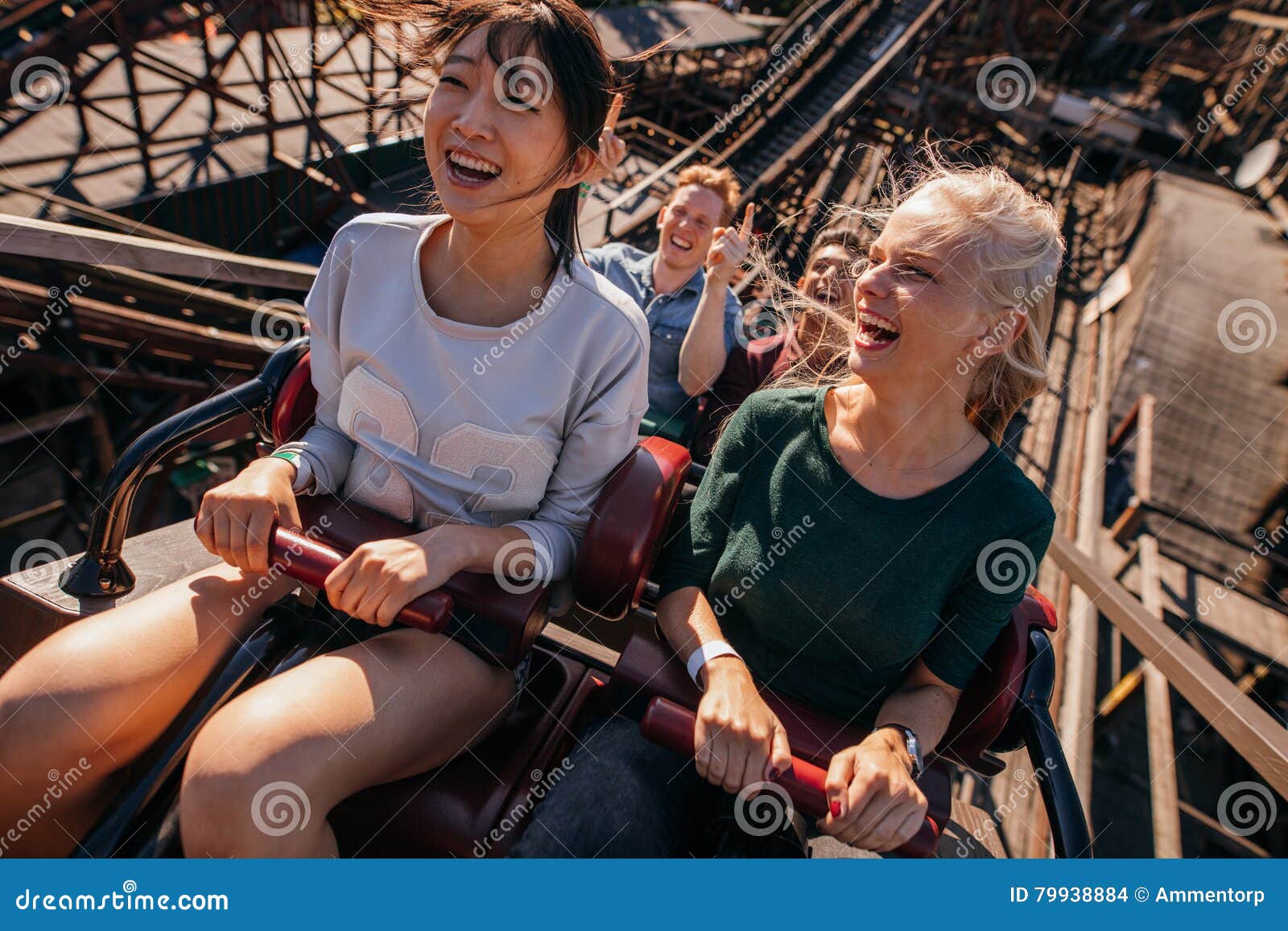 Smiling Young People Riding a Roller Coaster Stock Photo - Image of