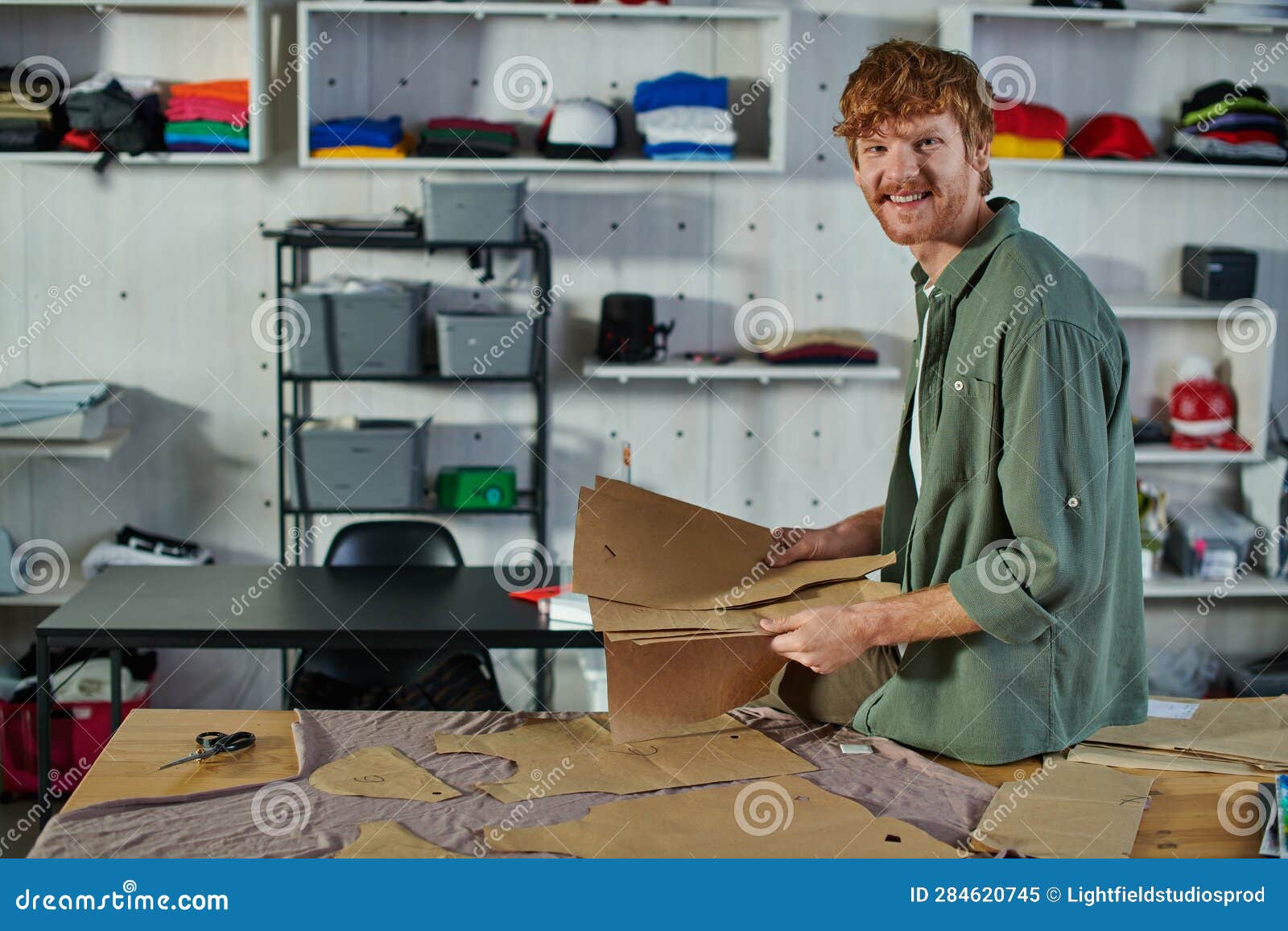 smiling young redhead craftsman looking at