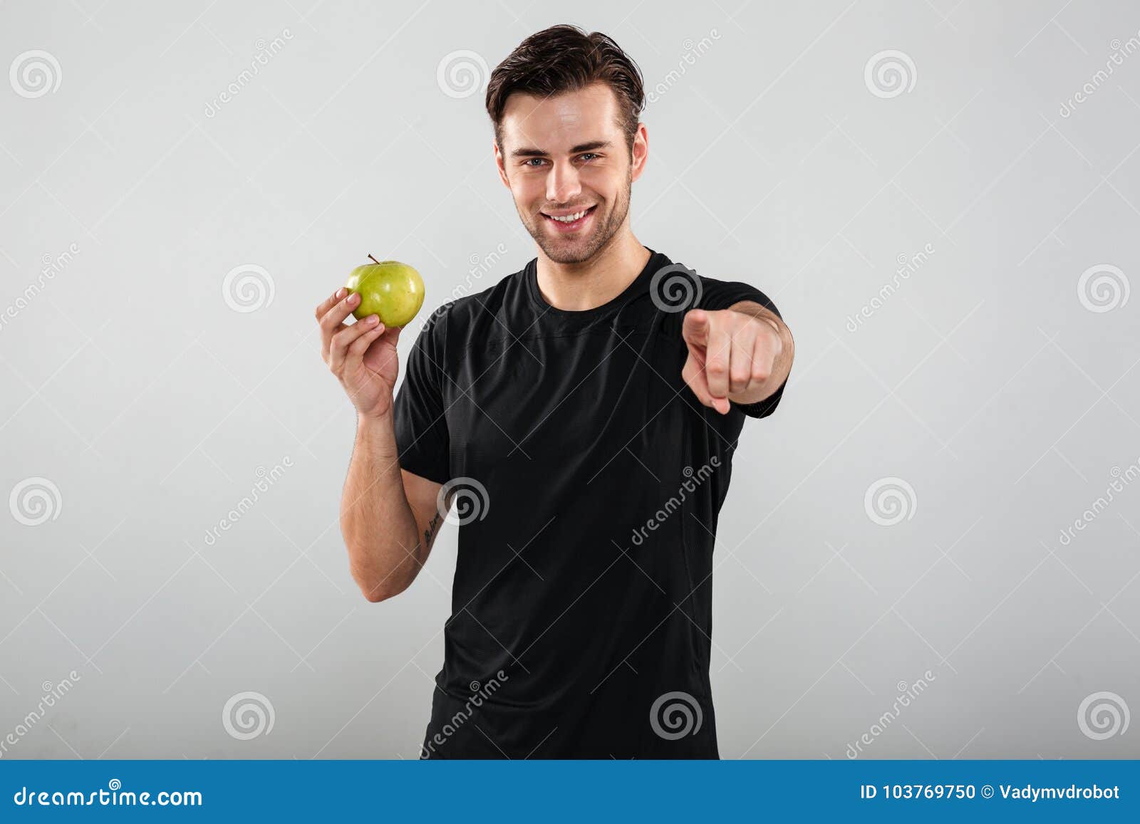 Smiling Young Sports Man Holding Apple Pointing At You. Stock Photo ...