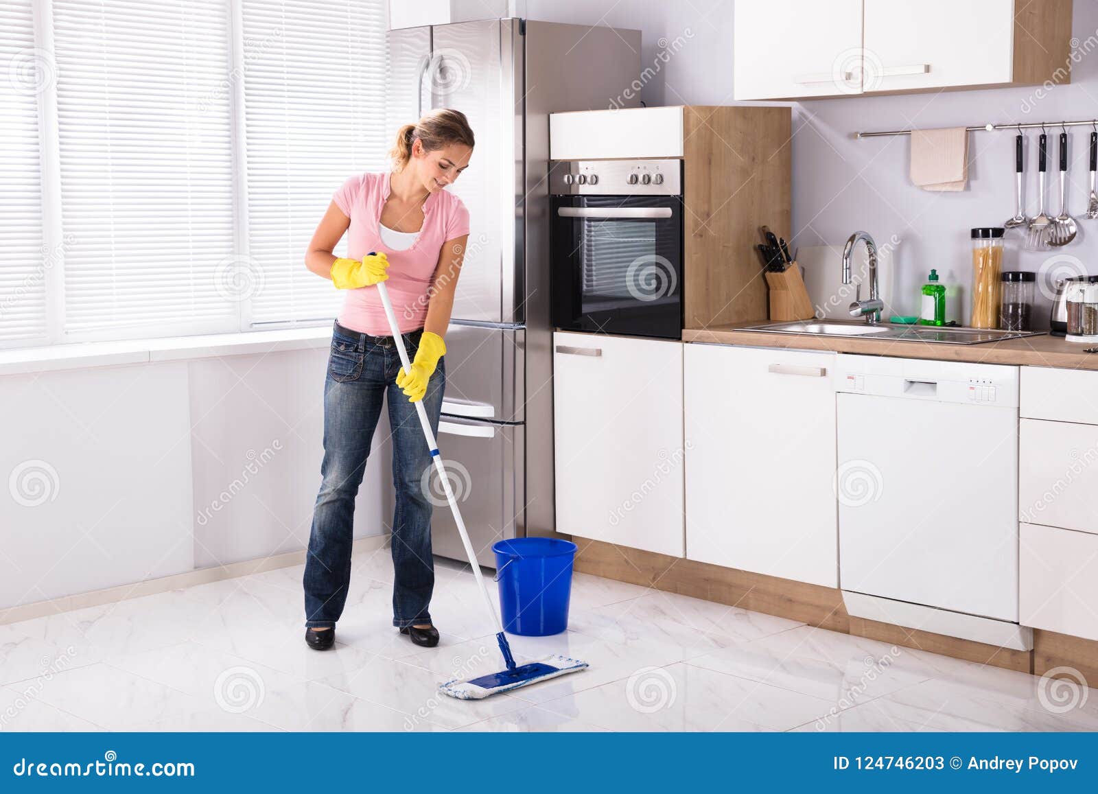 Woman Using Washing Machine Cleaning Clothes Kitchen Stock Photo by  ©AndreyPopov 387106822