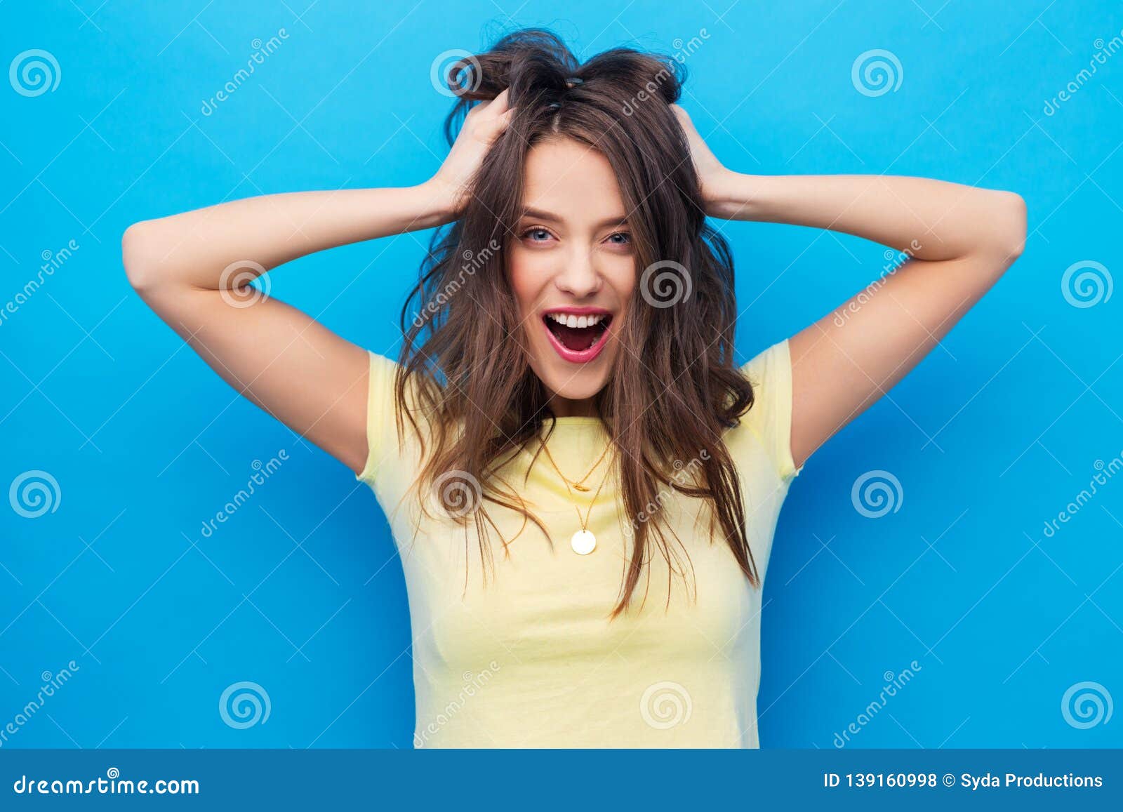 Smiling Young Woman Holding To Her Head or Hair Stock Photo - Image of ...