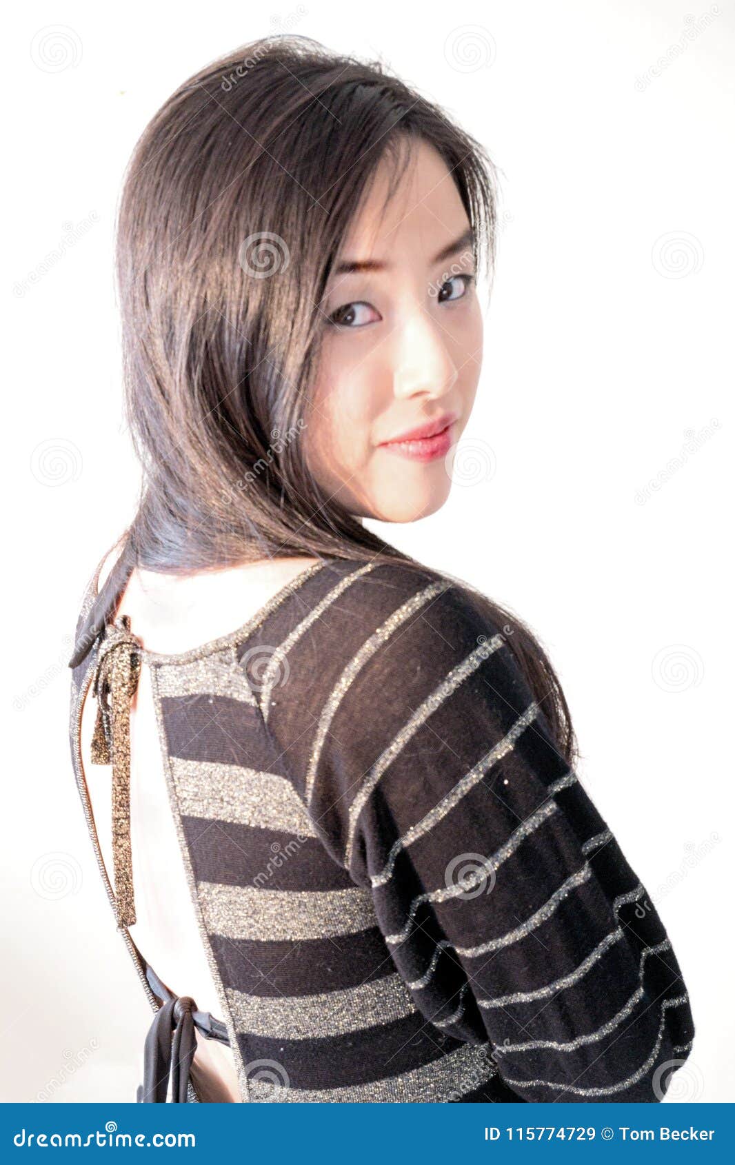 Smiling Young Woman Looks Back Over Her Shoulder Stock Image - Image of ...