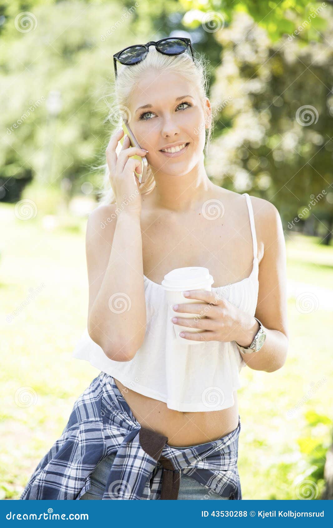 Smiling Young Woman With Phone And Coffee In Park Stoc