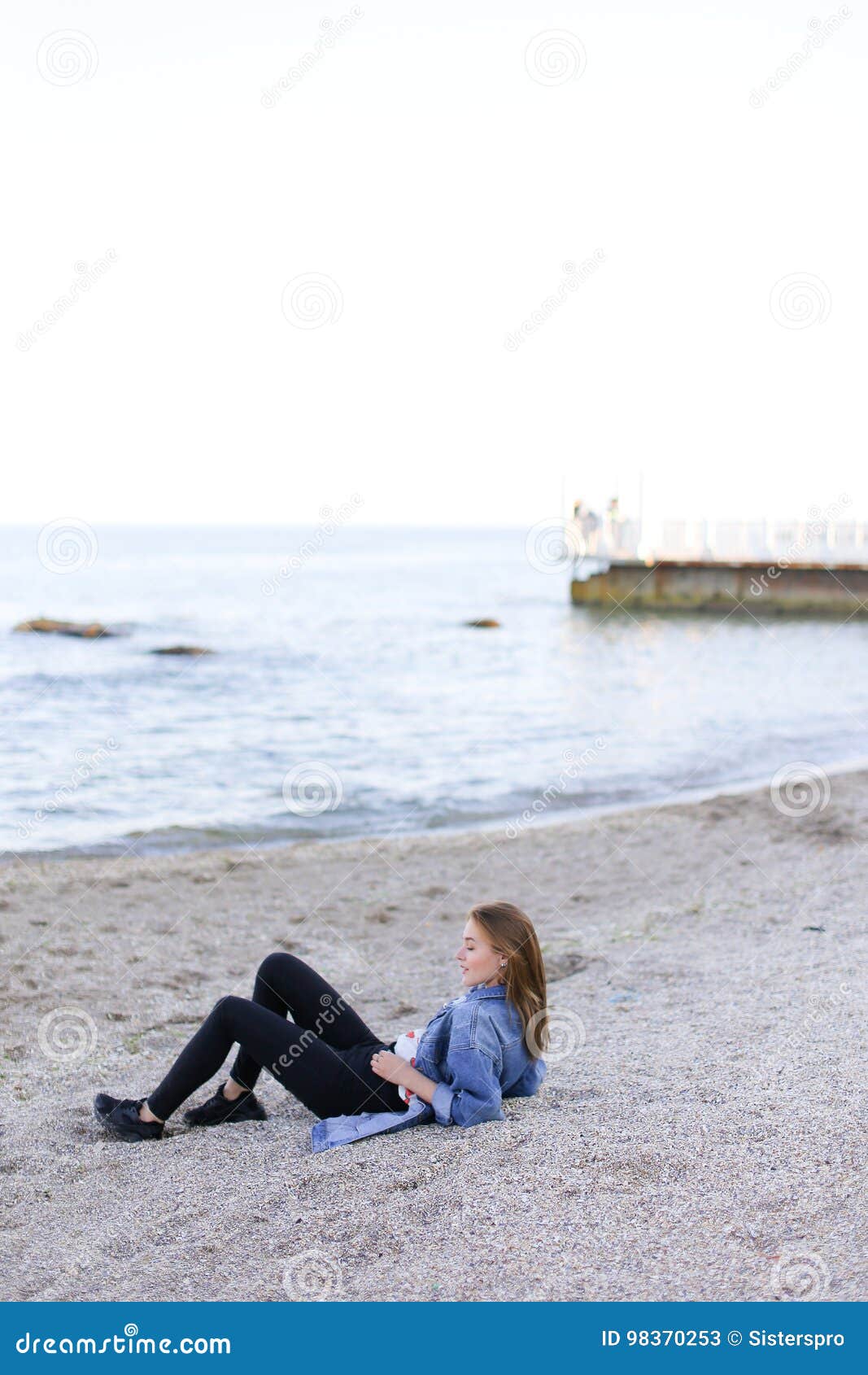 Young beautiful girl posing by the sea 11341715 Stock Photo at Vecteezy