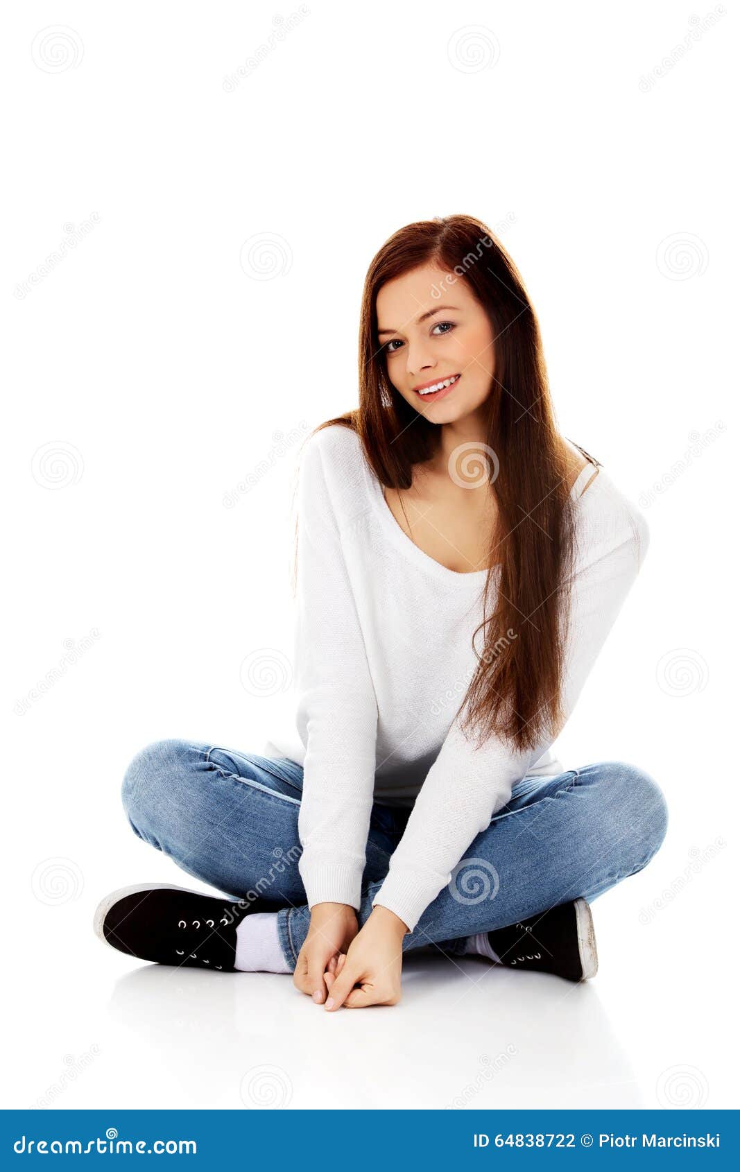 Smiling Young Woman Sitting on a Floor with Legs Crossed Stock Photo ...