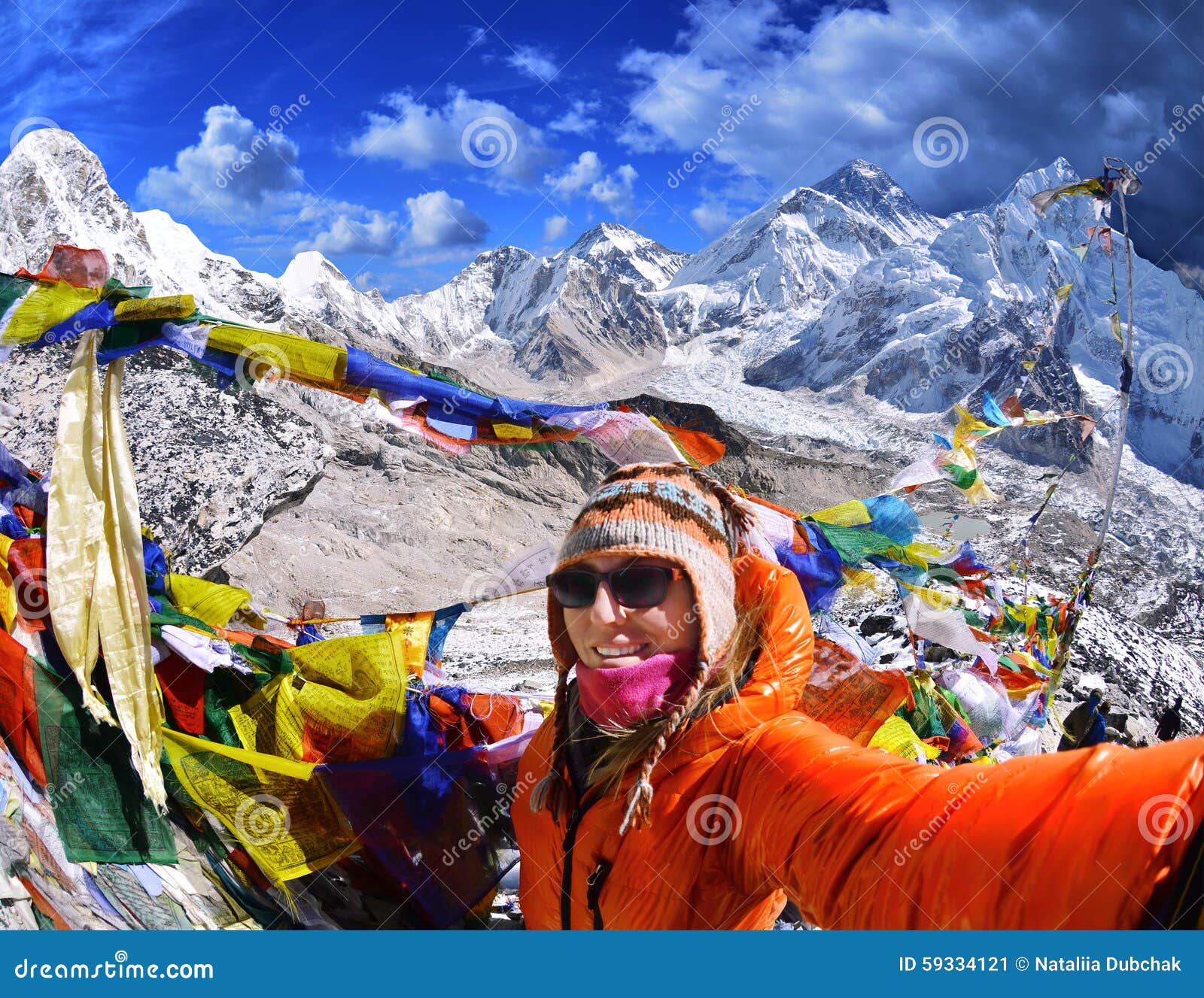 smiling young woman takes a selfie on mountain peak kala patth