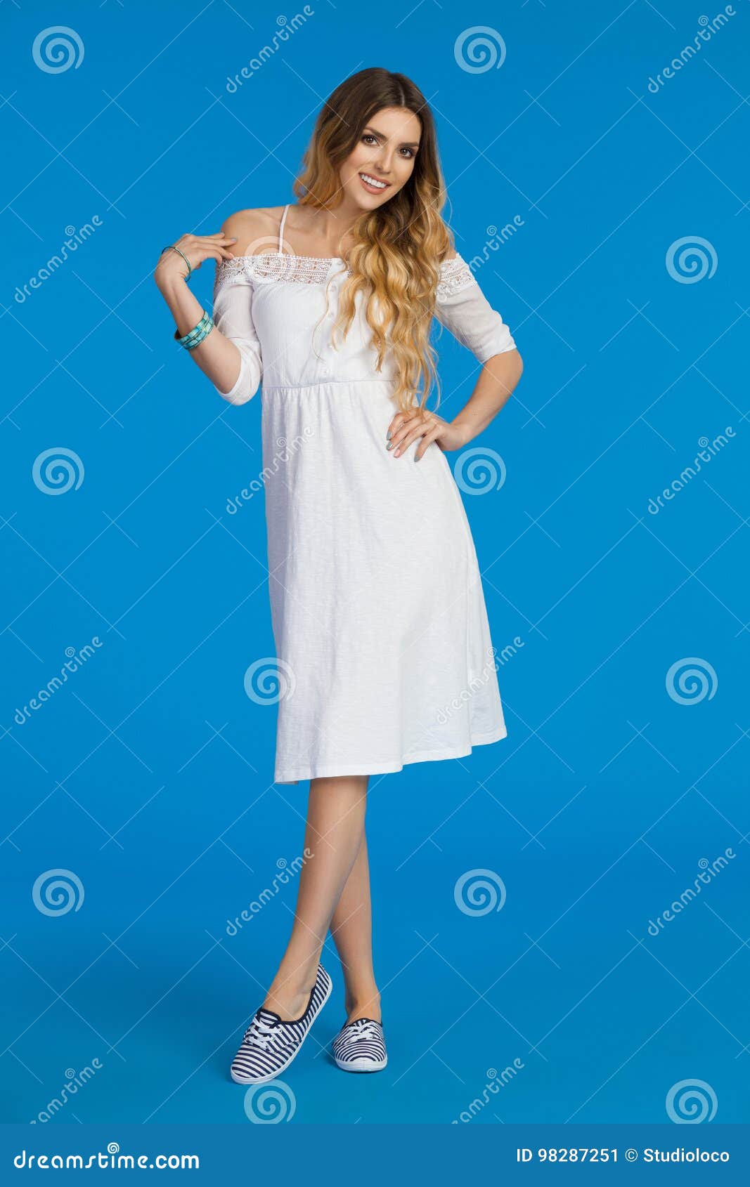 Smiling Young Woman in White Summer Dress and Striped Sneakers Stock ...