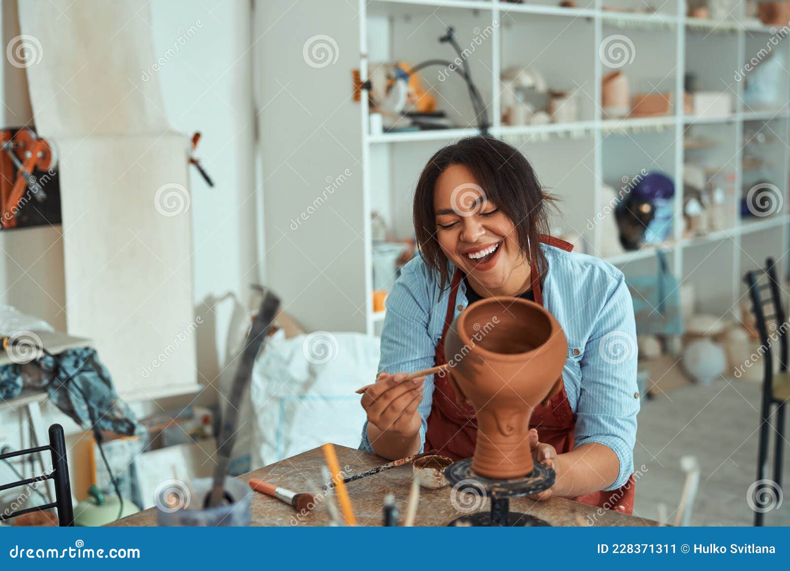 Smiling Young Woman Working in Art Pottery Studio Stock Image