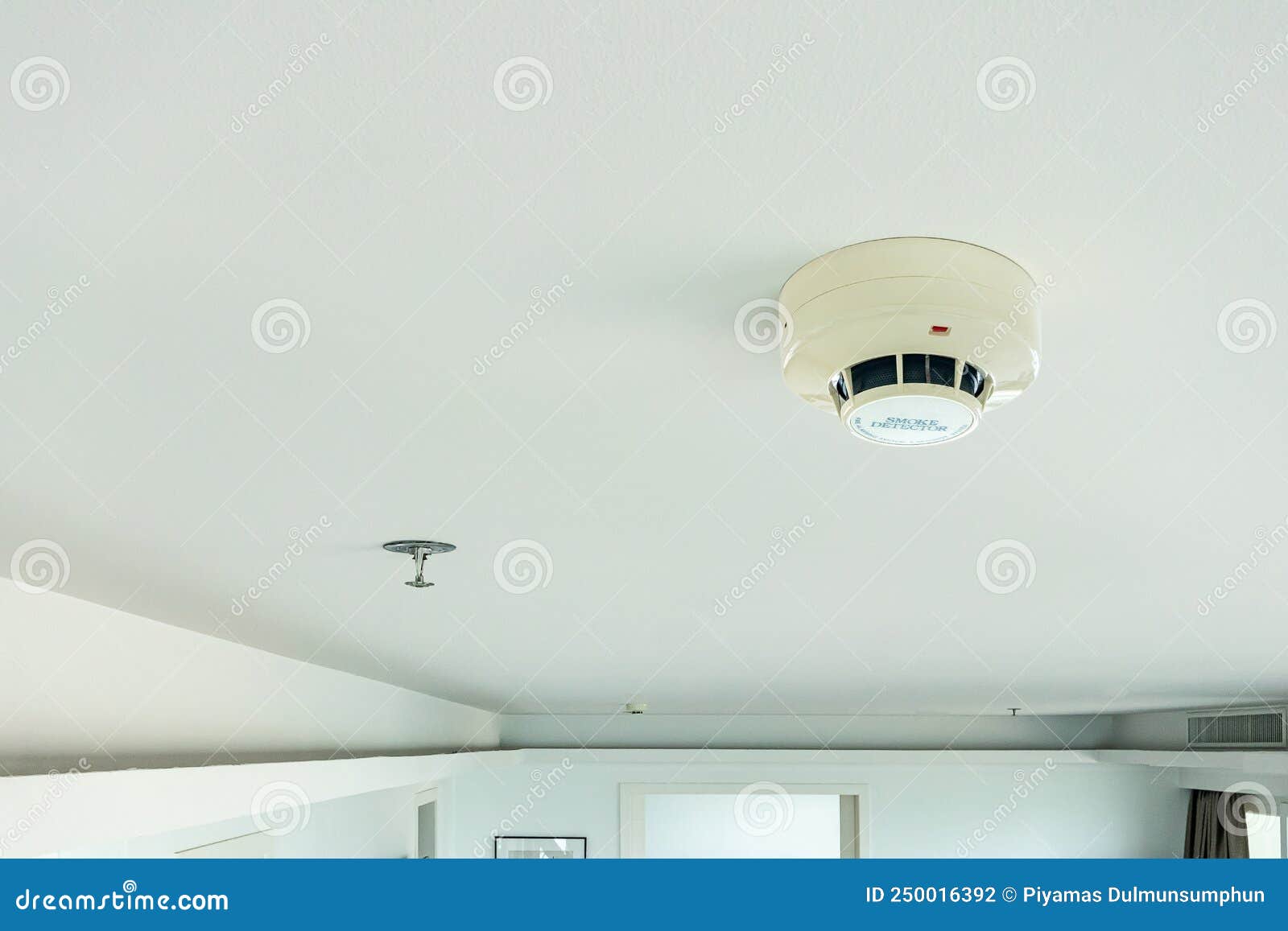 smoke detector and fire sprinkler on ceiling, fire alarming system and security system at home property for safety domestic life.
