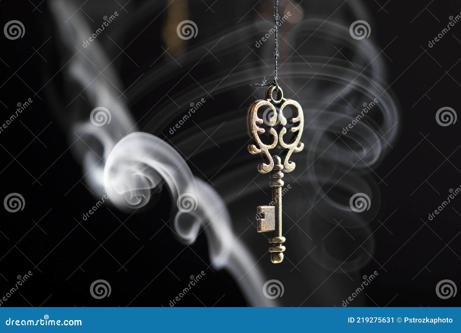 Smoke Flowing through the Key on the Black Background Stock Image
