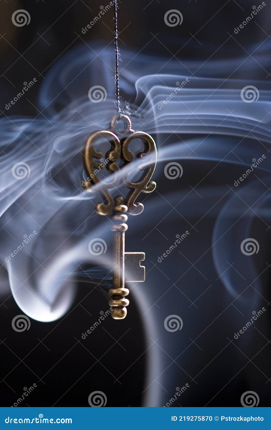 Smoke Flowing through the Key on the Black Background Stock Photo