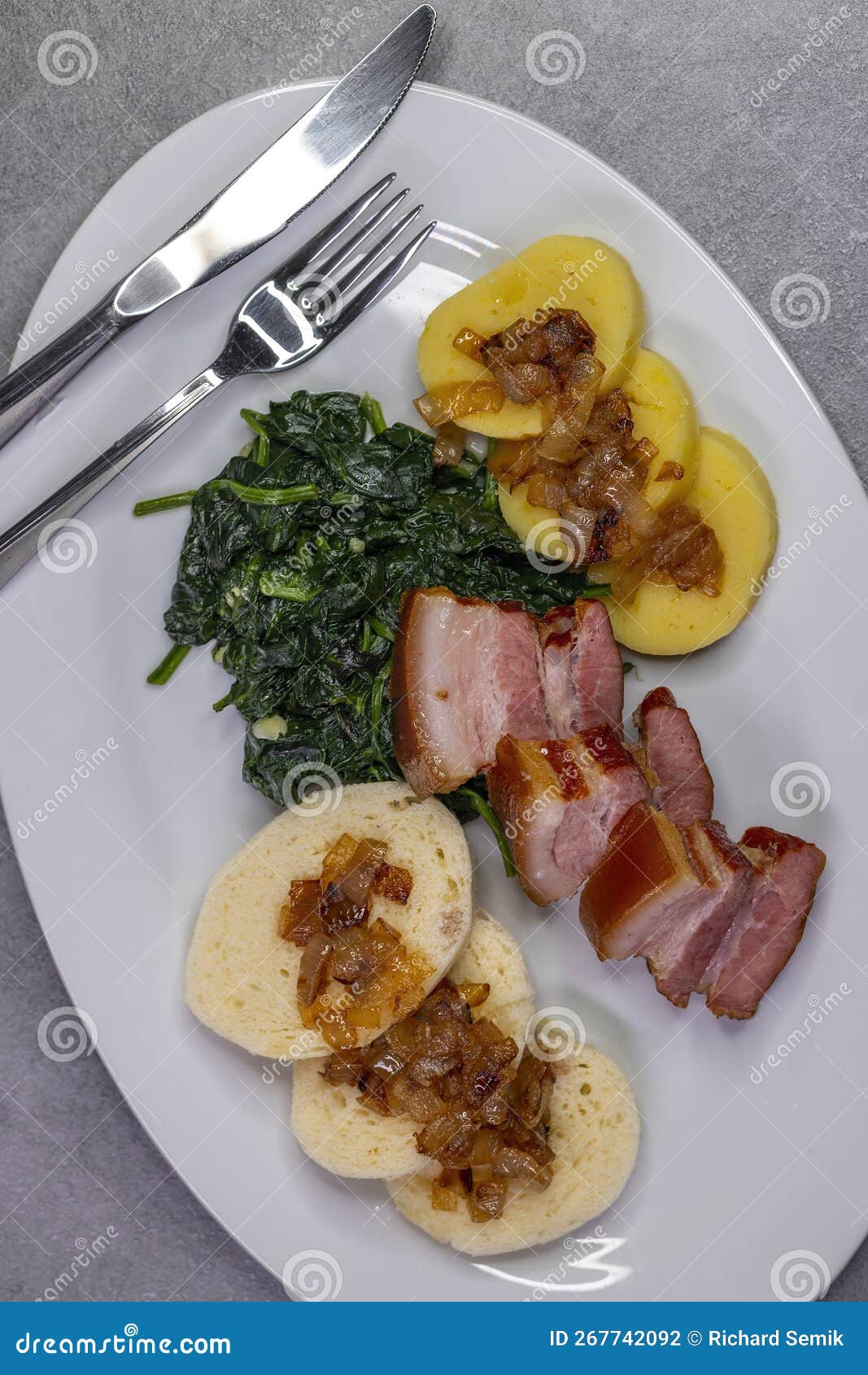 Smoked Flank with Potato and Bread Dumplings and Spinach Stock Photo