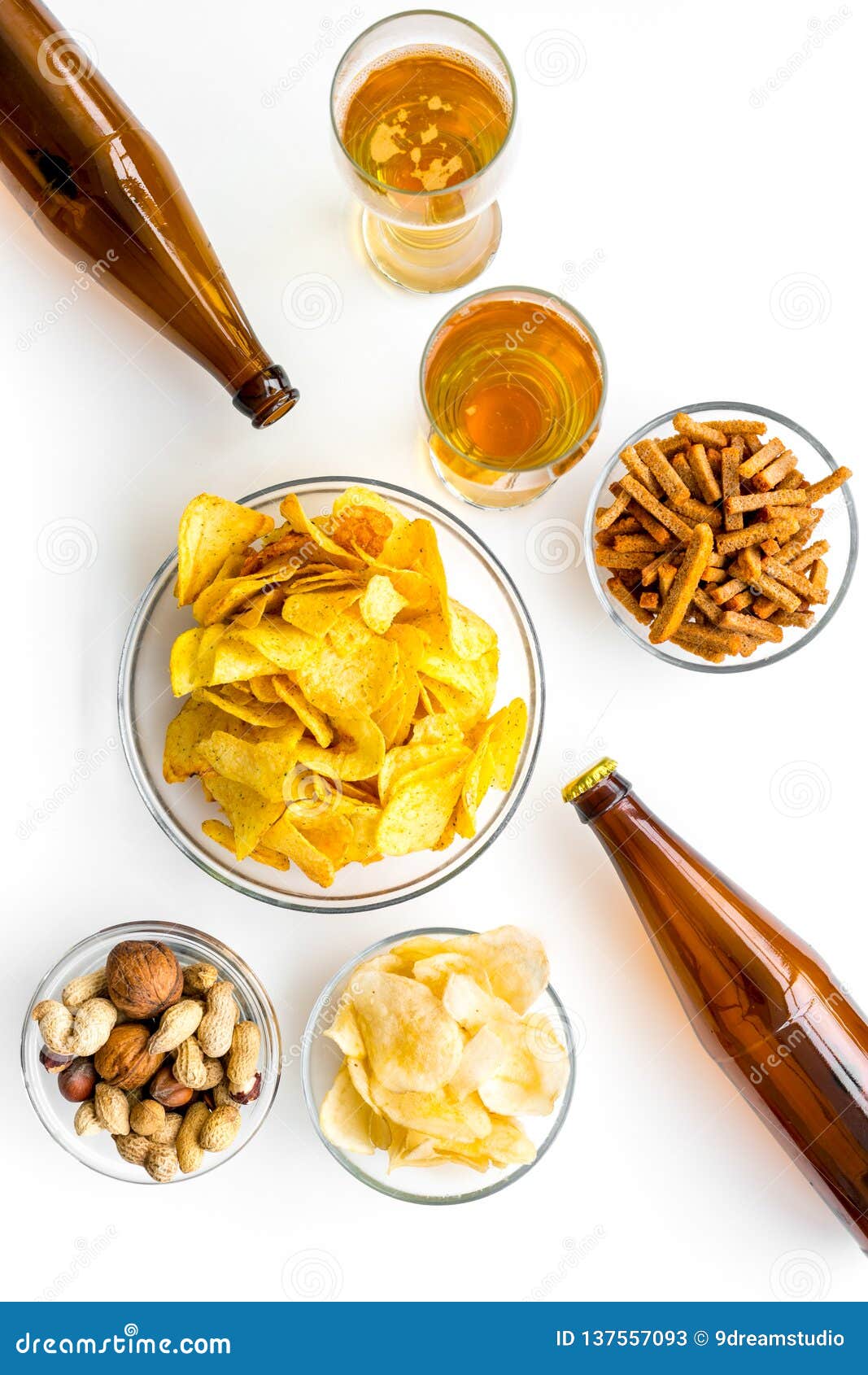 Snacks and Beer. Chips, Nuts, Rusks Near Beer on White Background Top