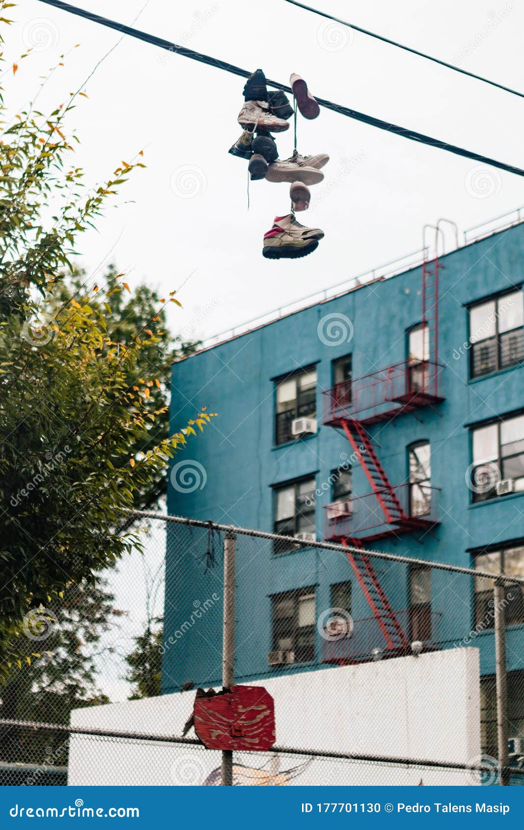 Shoes hanging from power line hi-res stock photography and images - Alamy