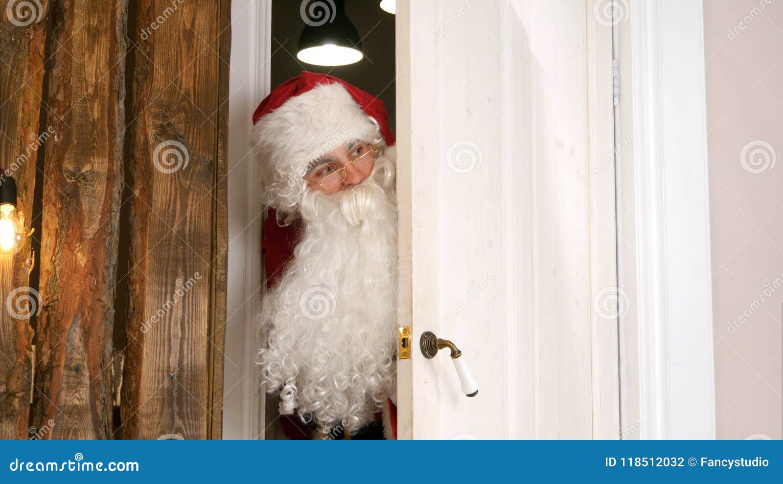 Sneaking Santa Claus Secretly Entering The Living Room Stock Photo