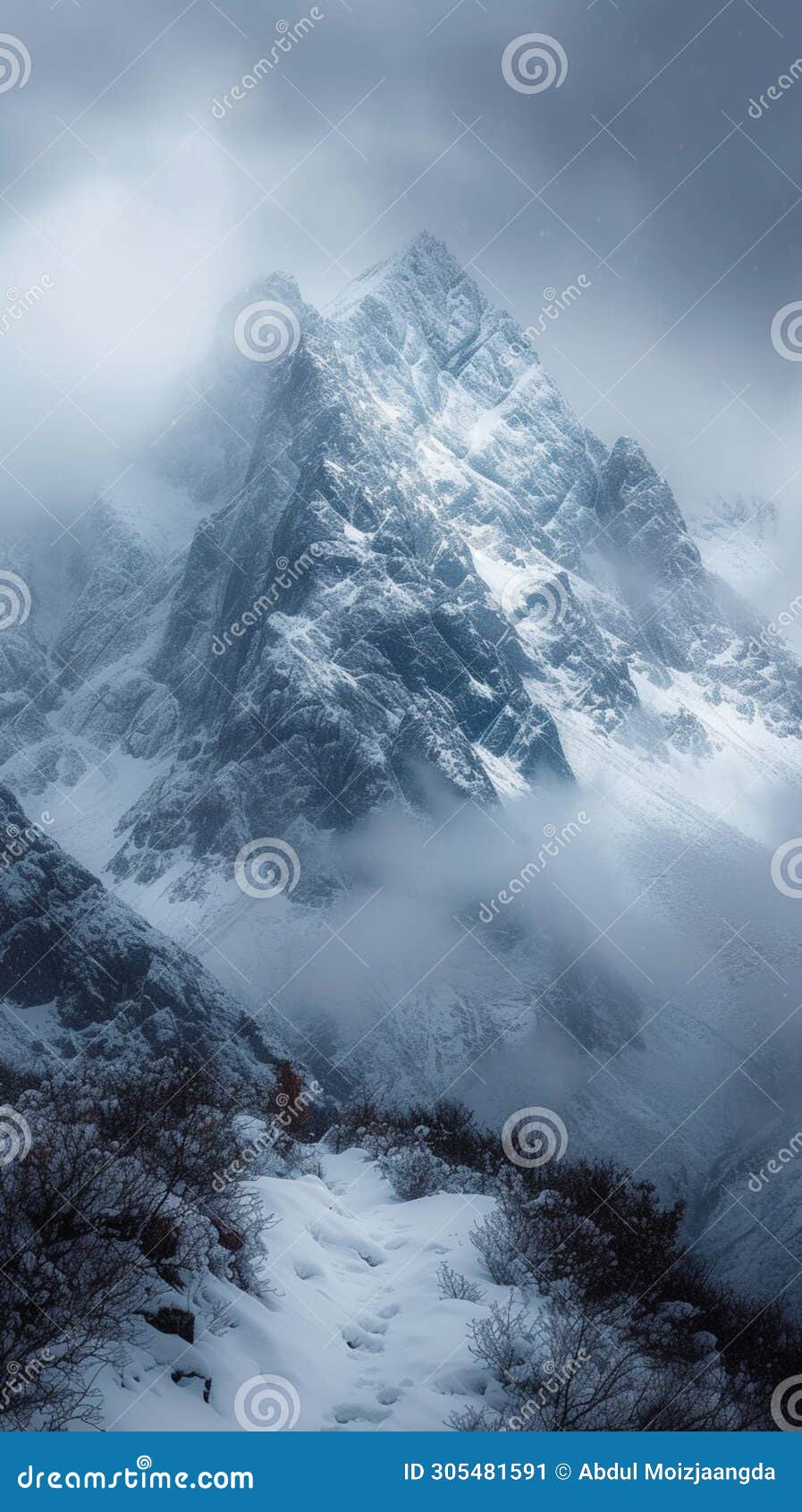 snow cloaked mountain stands tall beneath a moody, overcast sky