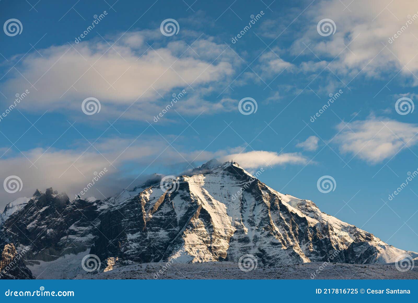 snow covered almirante nieto mountain with clouds passing over the peak