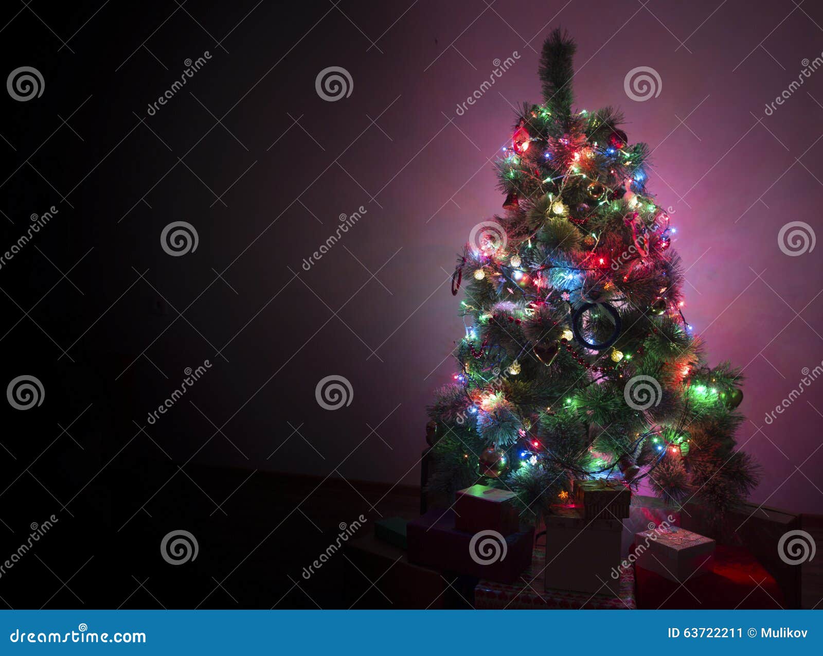 Snow Covered Christmas Tree with Multi Colored Lights Stock Image