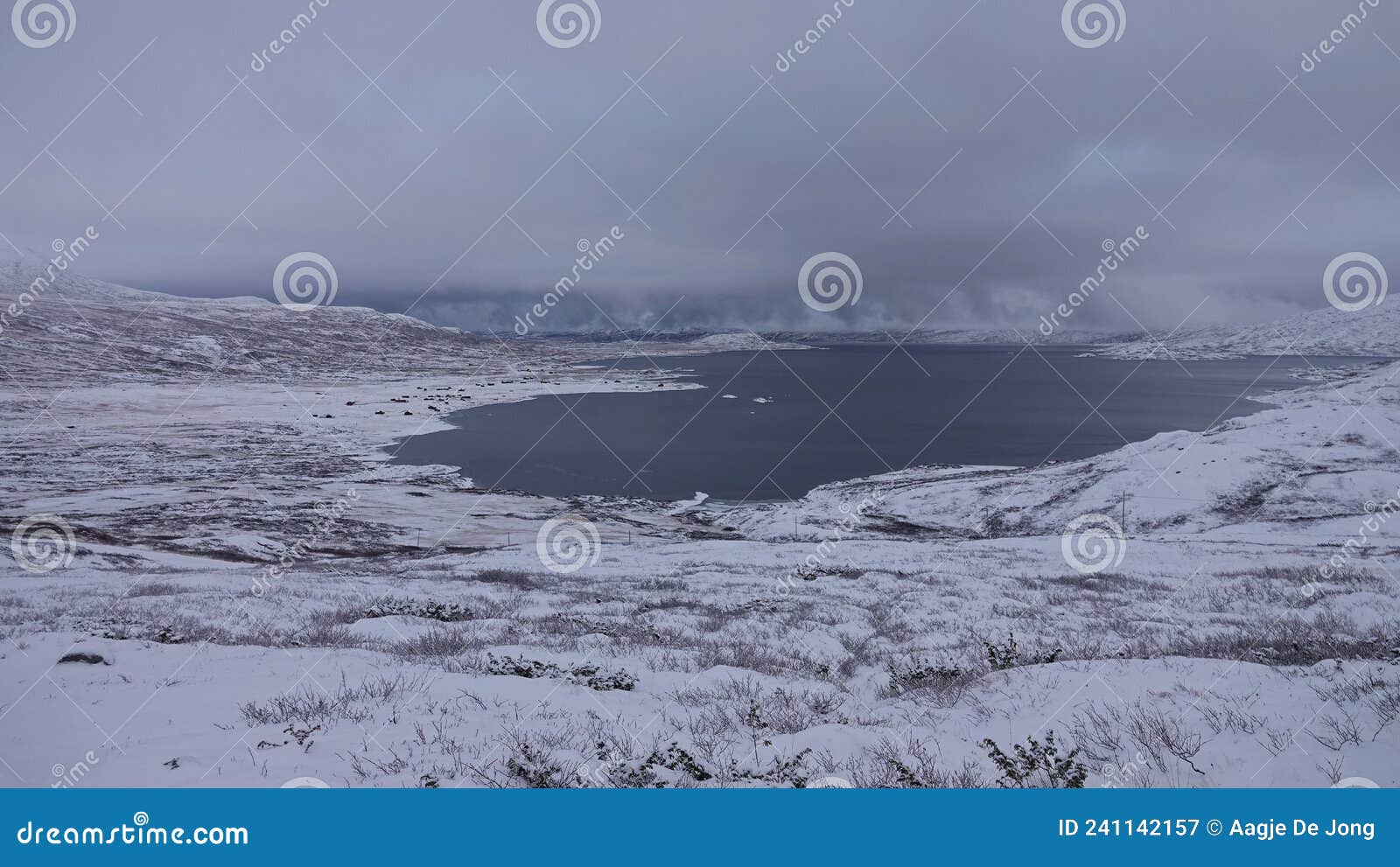 snow covered lake on valdresflye pass in norway in autumn