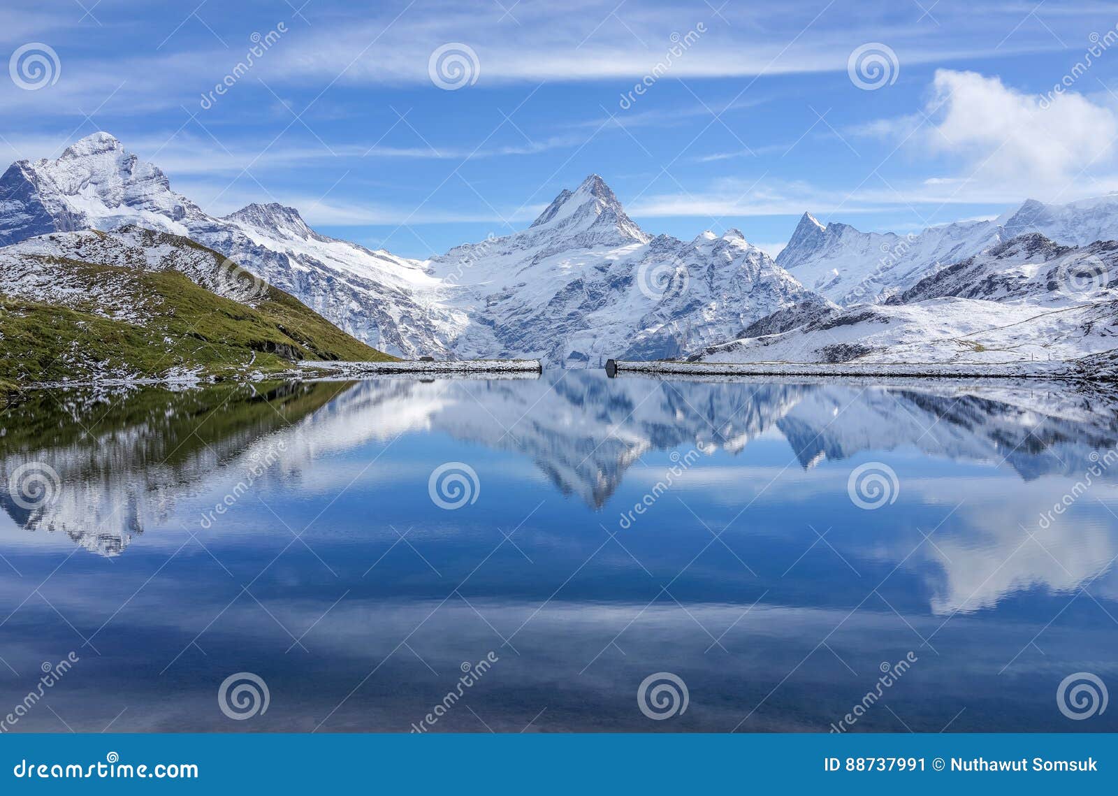 the snow mountain with reflection in lake and clear blue sky in switzerland