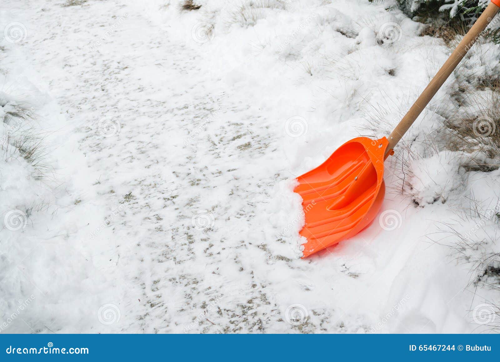 Snow Removal. Orange Shovel in Snow. Stock Photo Image of remove