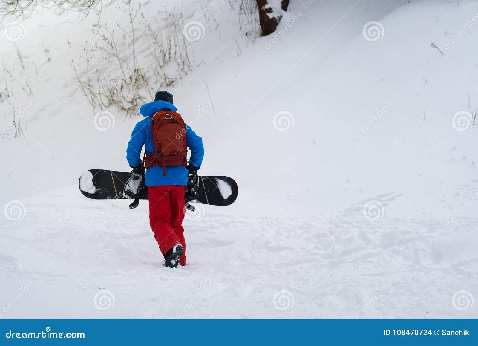 Snowboarder with Backpack Climbs Up the Slope Stock Photo Image of