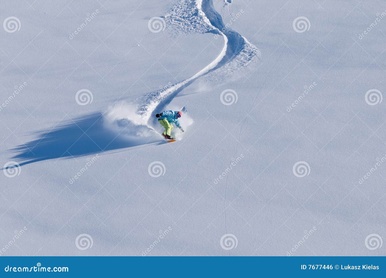 snowboarder having fun in deep backcountry snow