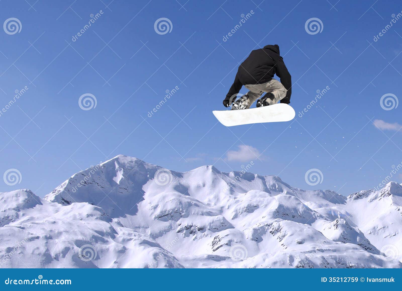 Snowboarder jumping. Snowboarder at jump inhigh mountains at sunny day