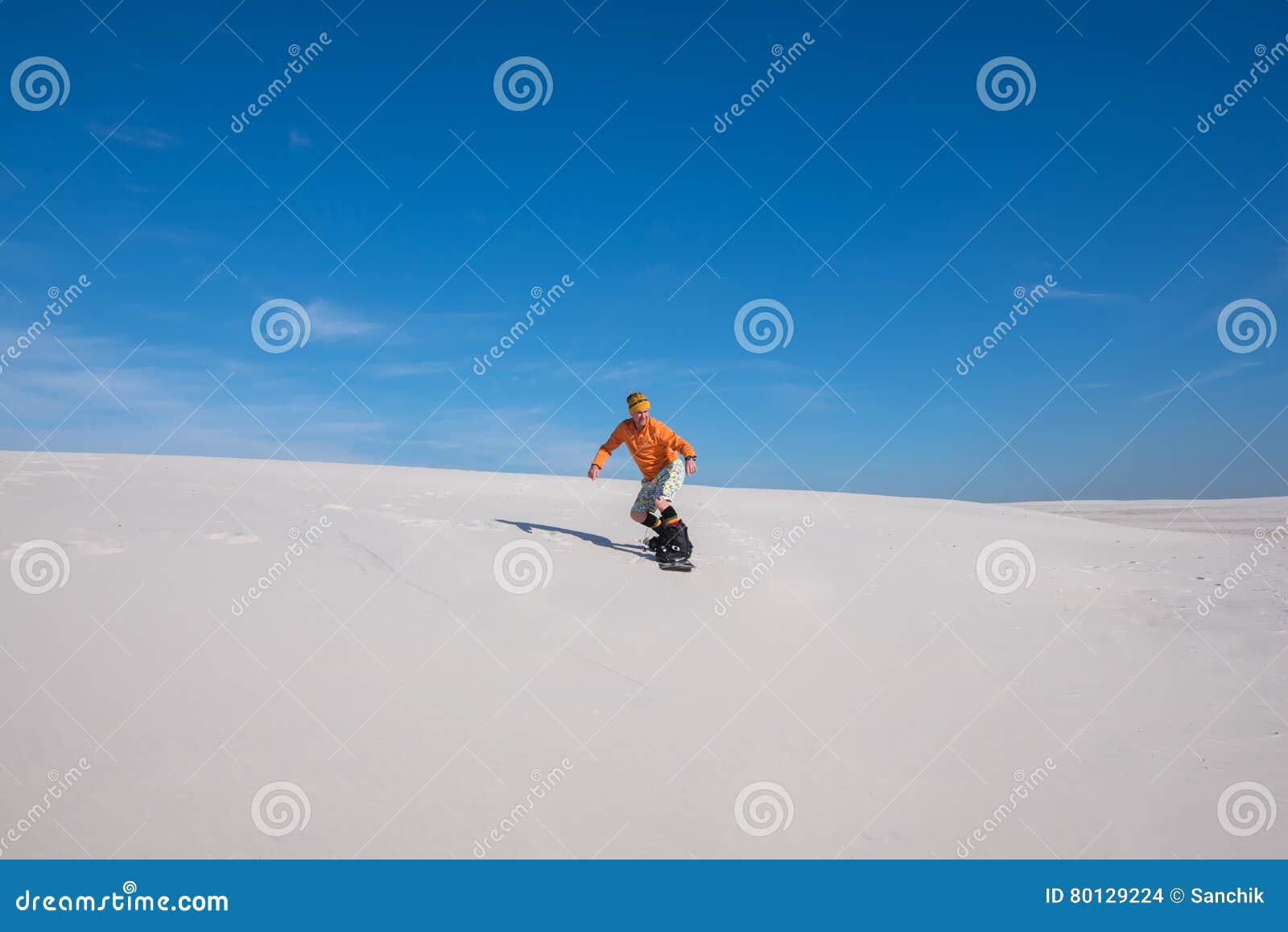 Snowboarder is Riding Down on the Sand Dune. Stock Photo - Image of ...