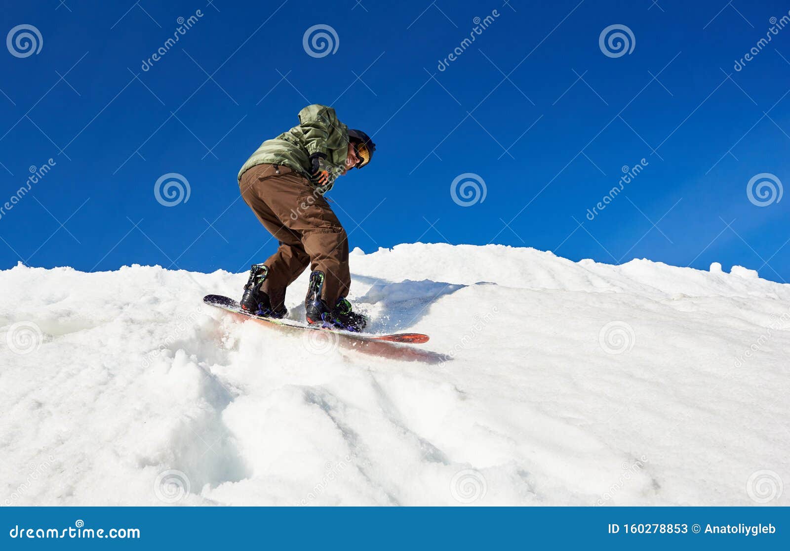 Snowboarder Riding Snowboard in Deep Snow Down Mountain Slope on ...